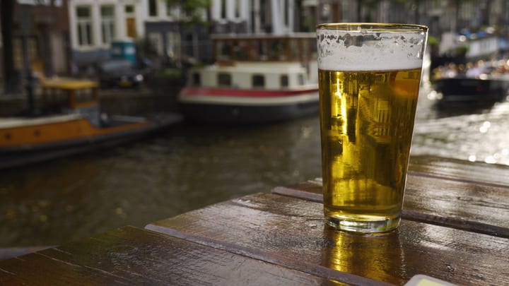 Image of Alcohol, Beer, Beverage, Glass, Water, Waterfront, Beer Glass, Liquor, Lager, Boat, Vehicle, Dining Table, 