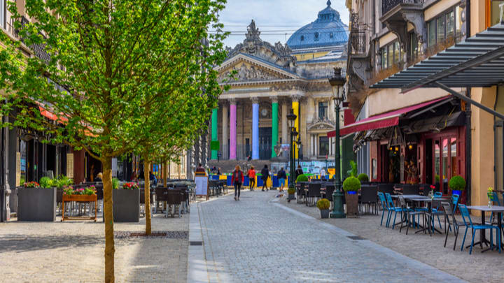 Image of Path, City, Road, Street, Urban, Sidewalk, Neighborhood, Indoors, Restaurant, Metropolis, Walkway, Person, Cafe, Plant, Cafeteria, Chair, Furniture, Dining Table, Table, Cobblestone, 