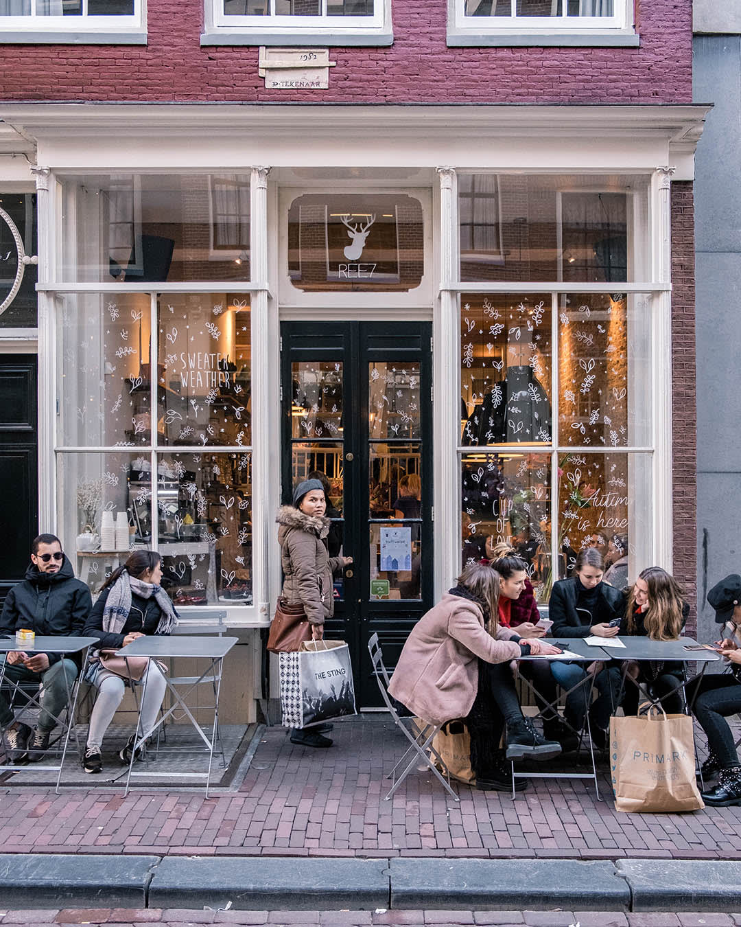 Image of Cafe, Indoors, Restaurant, Urban, Bag, Handbag, Adult, Female, Person, Woman, Building, Male, Man, Coat, Boy, Teen, City, 