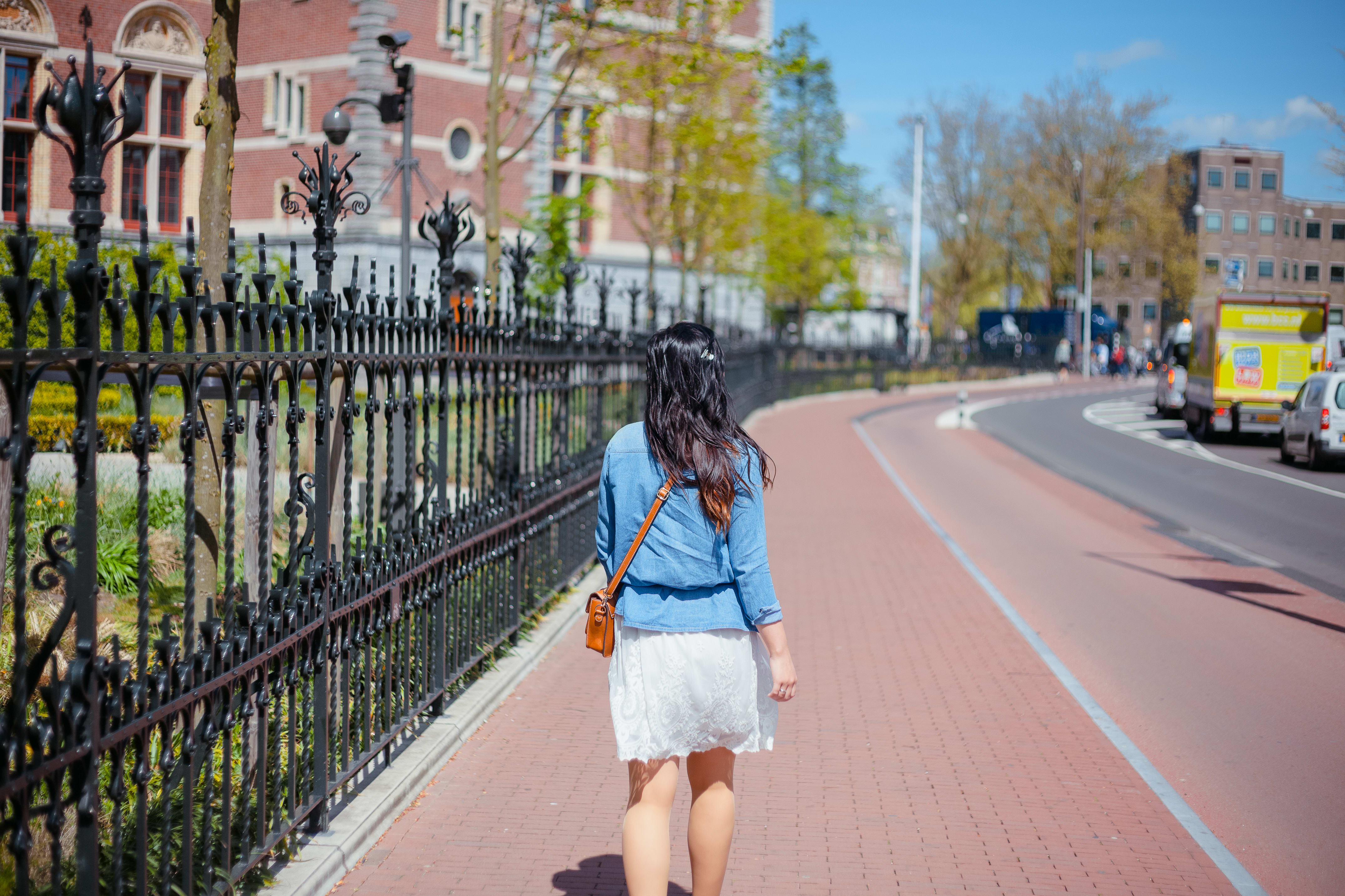 Image of Skirt, Female, Girl, Person, Teen, Shorts, Car, Vehicle, Truck, City, Accessories, Bag, Handbag, Walking,