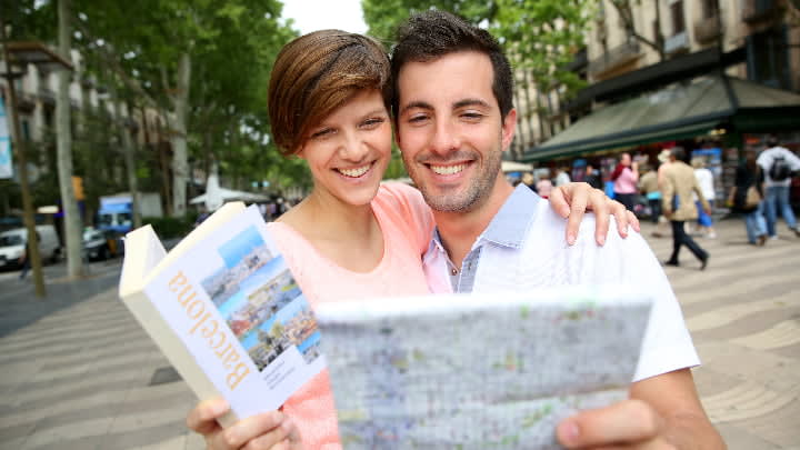 Image of Person, Reading, City, Street, Urban, Book, Publication, Advertisement, Poster, Face, Head, Photography, Portrait, People, Adult, Male, Man, Accessories, Handbag, Path, 