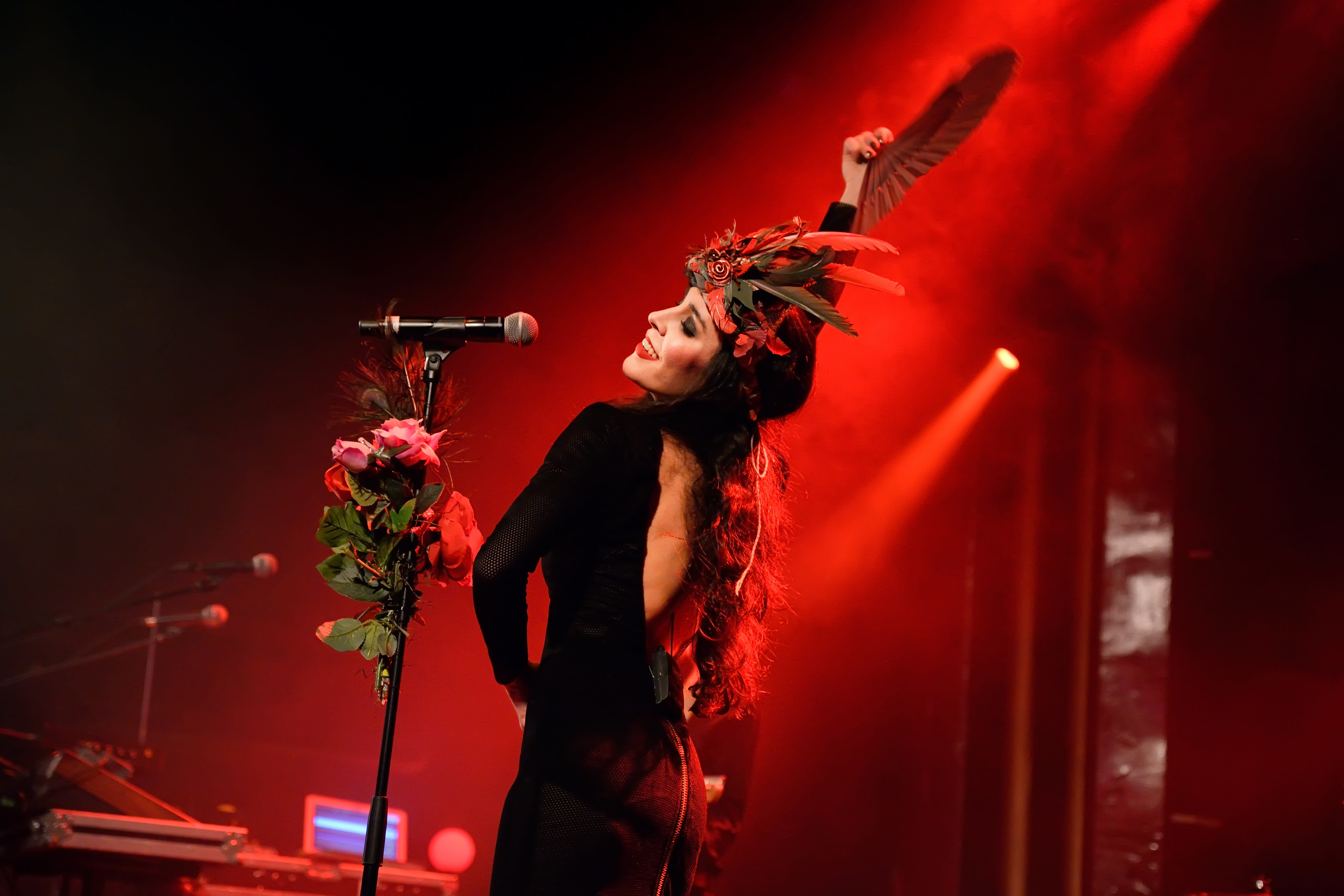 Image of Concert, Crowd, Person, Adult, Female, Woman, Performer, Solo Performance, Microphone, Lighting, Flower, Flower Arrangement, 