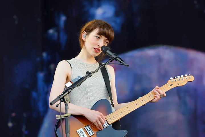 Image of Adult, Female, Person, Woman, Performer, Solo Performance, Guitar, Musical Instrument, Microphone, 