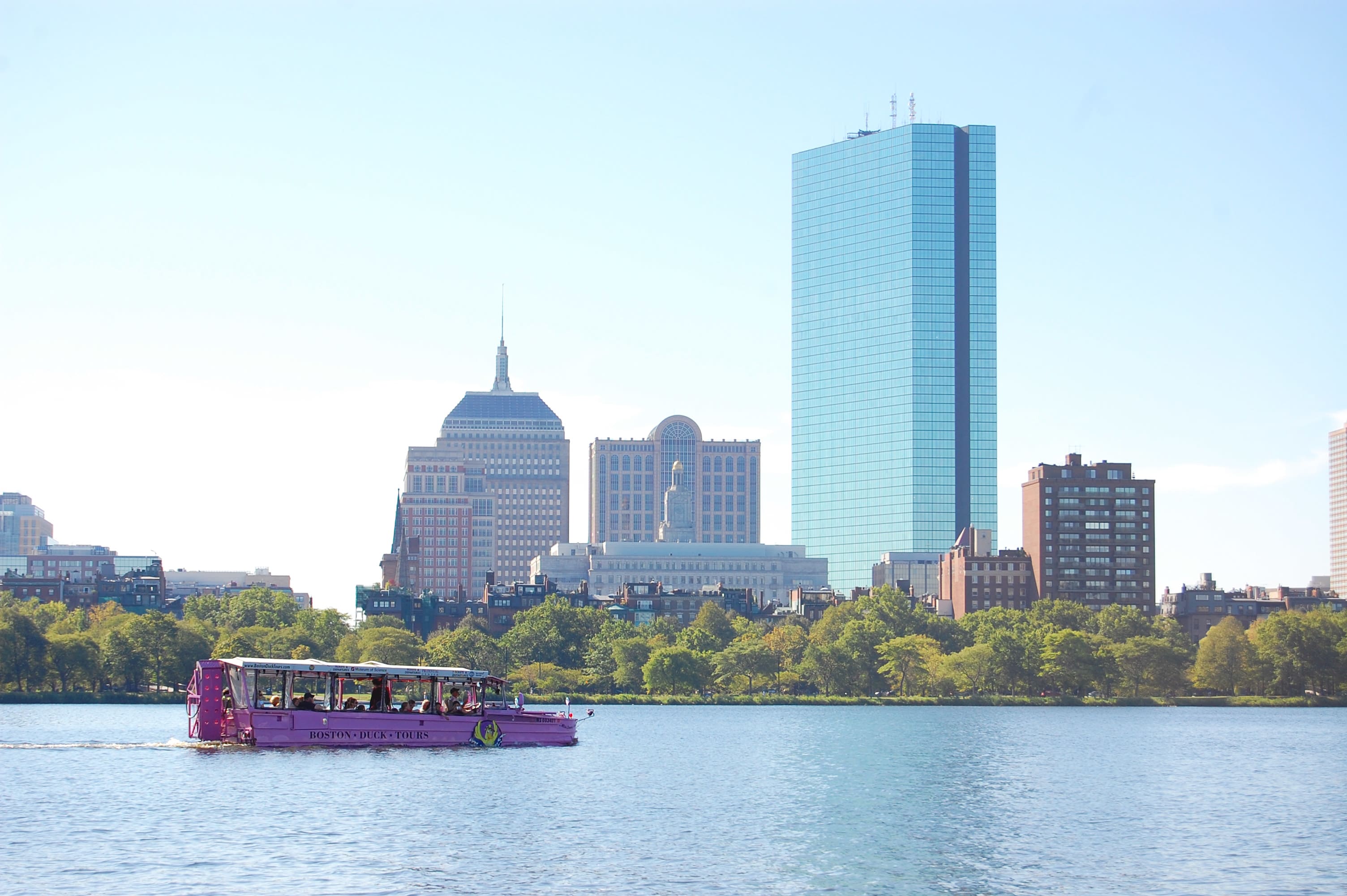 Image of City, Metropolis, Urban, Building, Cityscape, Barge, Boat, Vehicle, Watercraft, Ferry, Office Building, Water, Waterfront, Person, High Rise, 