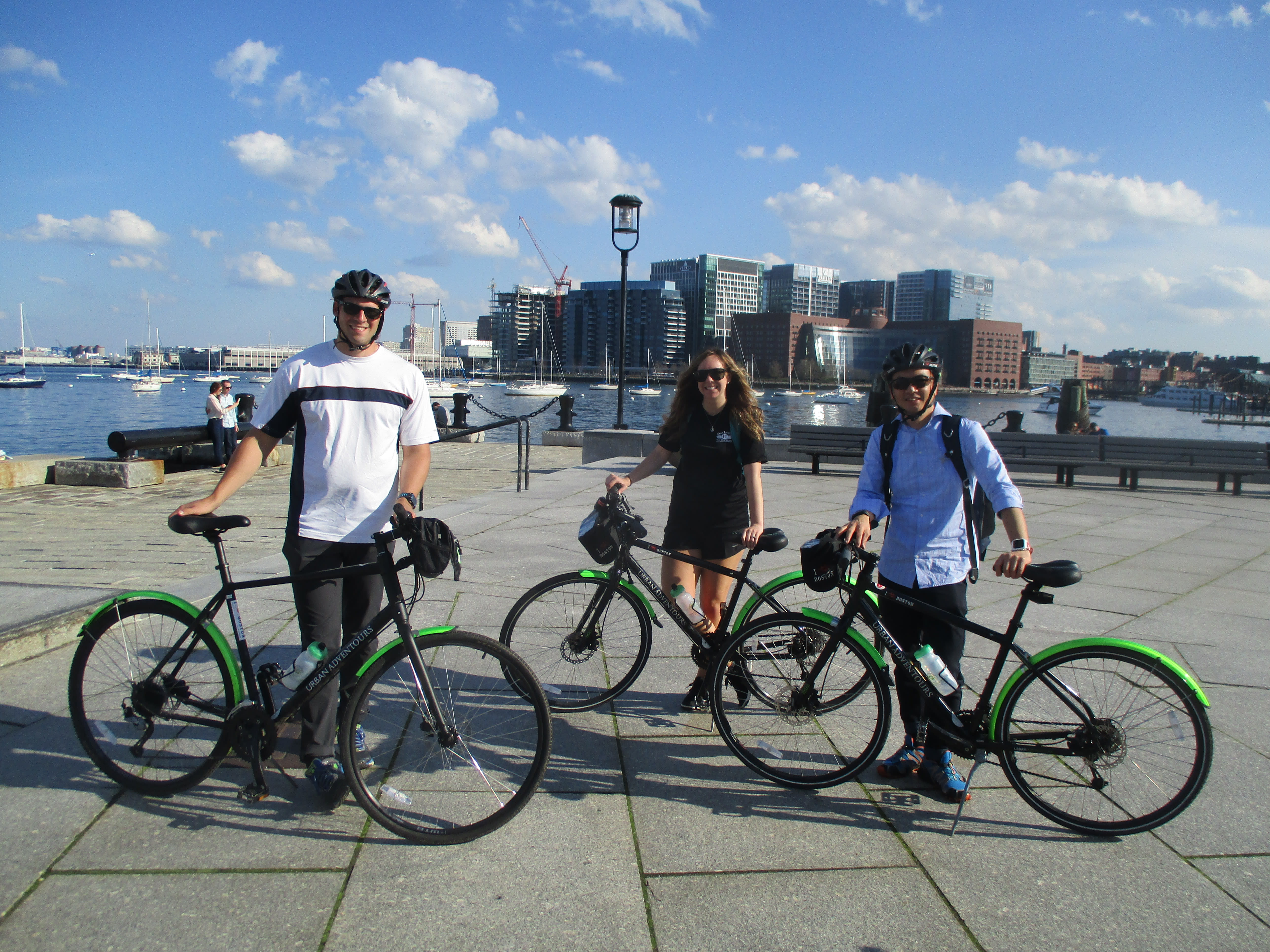 Image of City, Bicycle, Vehicle, Female, Girl, Person, Teen, Boy, Male, Metropolis, Urban, Wheel, Shorts, Water, Waterfront, Helmet, Boat, 