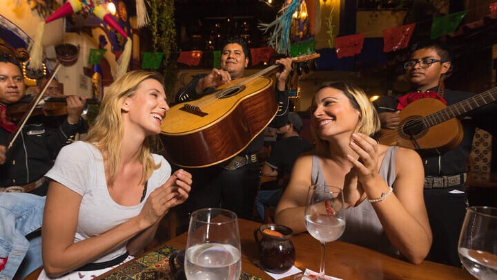 Image of Cup, Dining Table, Female, Girl, Person, Teen, Adult, Woman, Guitar, Musical Instrument, Male, Man, Urban, 