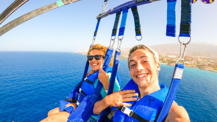 Image of Face, Head, Person, Photography, Portrait, Lifejacket, Vest, Finger, Hand, Accessories, Sunglasses, Selfie, Adult, Female, Woman, Nature, Outdoors, Sky, Sea, Water, Glasses,