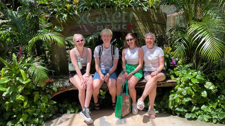 Image of Potted Plant, Shorts, Vegetation, Summer, Herbal, Tree, Garden, Nature, Outdoors, People, Person, Backyard, Yard, Bench, Furniture, Land, Rainforest, Planter, Photography, Portrait, Jungle, Grass, Park, Female, Girl, Teen, Boy, Male, Accessories, Bag, Handbag, Glasses, Adult, Woman, Dress, 