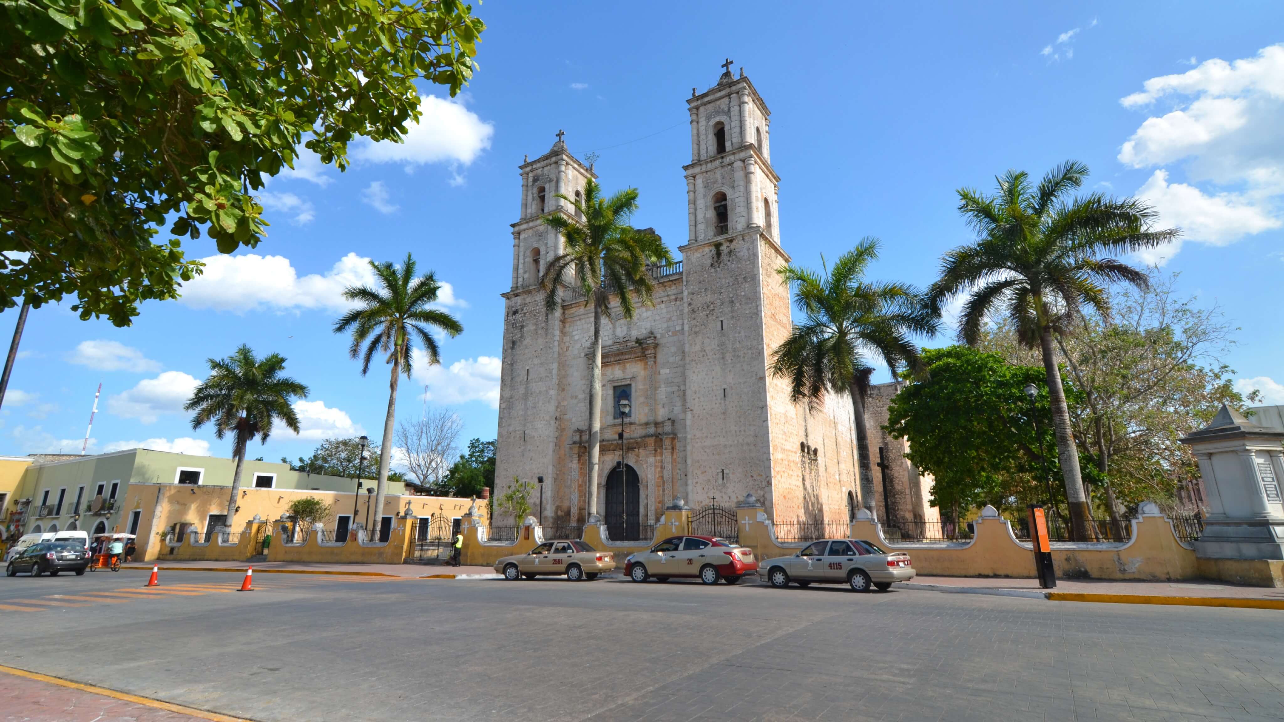 Image of Bell Tower, Tower, City, Arch, Clock Tower, Gothic Arch, Road, Street, Urban, Cathedral, Church, Car, Vehicle, Tree, Person, 