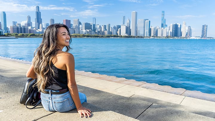 Image of City, Accessories, Bag, Handbag, Urban, Female, Girl, Person, Teen, Cityscape, Sitting, Water, Waterfront, Pants, 