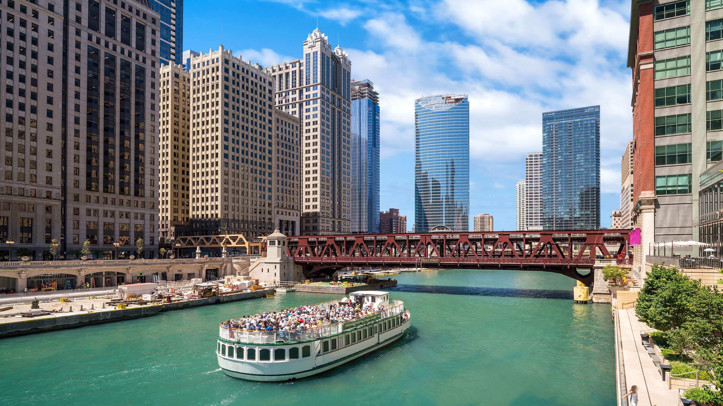 Image of City, Urban, Cityscape, Metropolis, Boat, Vehicle, Water, Waterfront, Condo, Housing, Person, High Rise, Office Building, Outdoors,