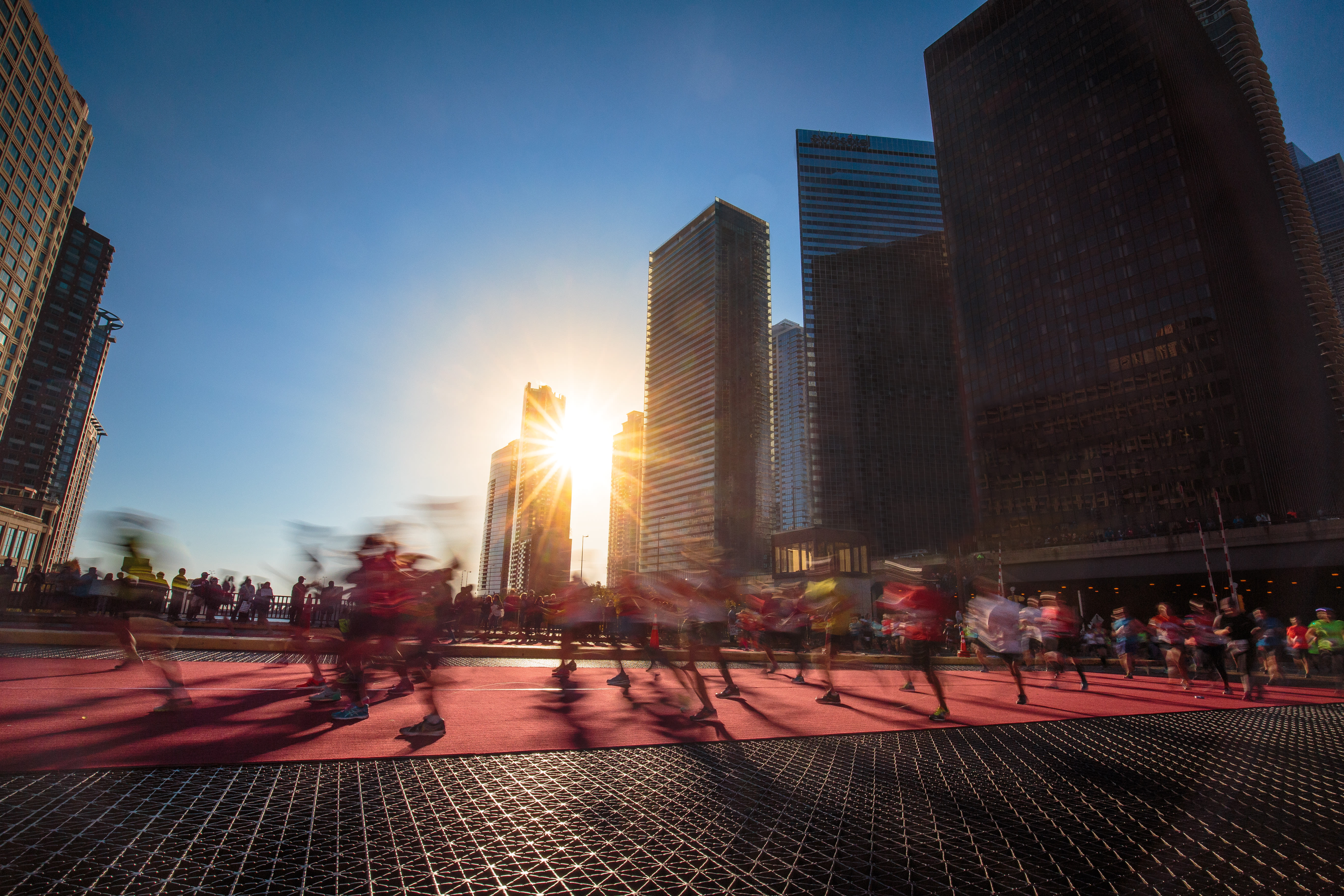 Image of City, Metropolis, Urban, Flare, Light, Sunlight, Road, Path, Street, Person, Nature, Outdoors, Sky, Office Building, High Rise, Cityscape, Condo, 