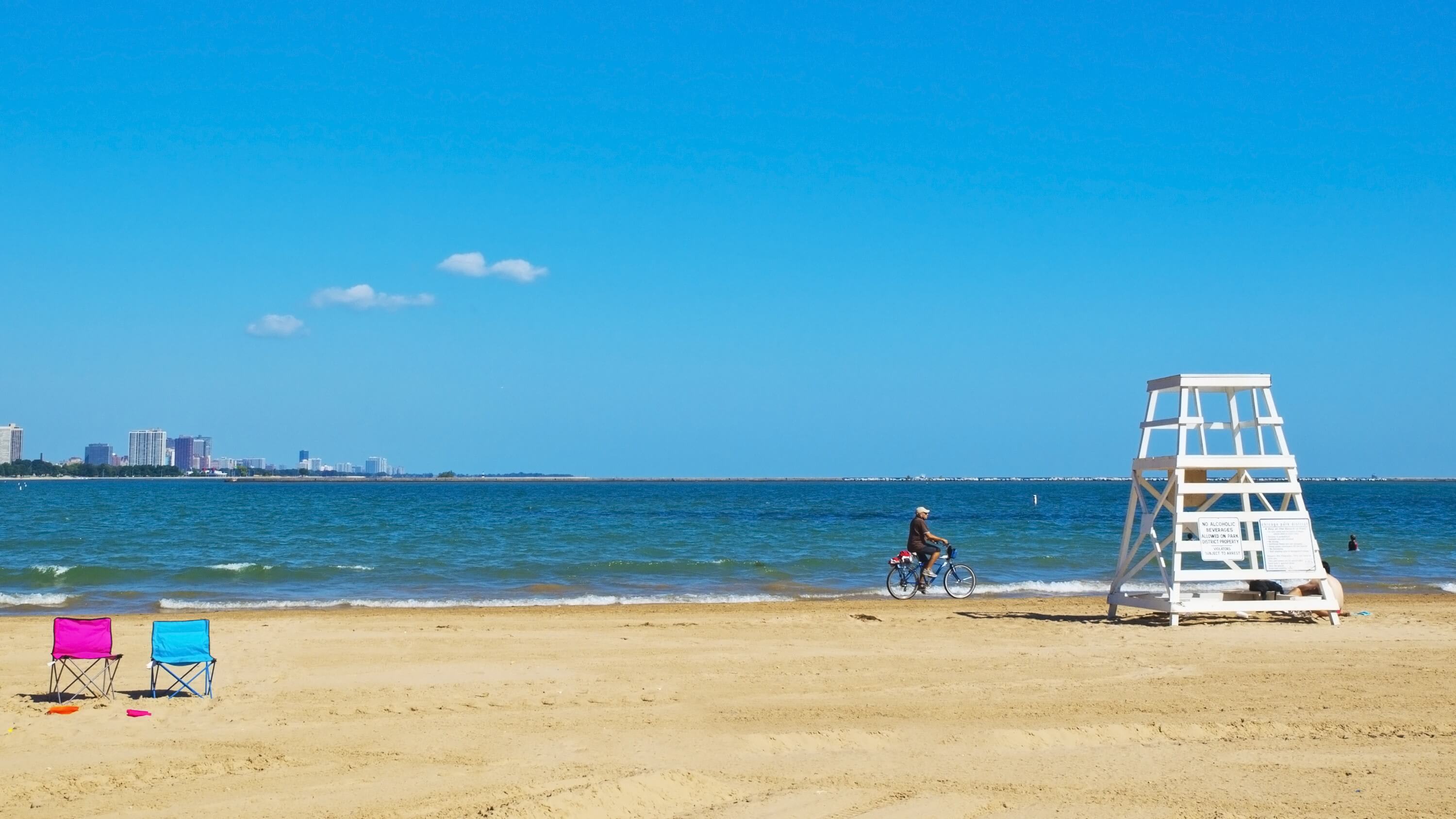 Image of Beach, Coast, Nature, Outdoors, Sea, Shoreline, Summer, Water, Chair, Furniture, Sky, Bicycle, Vehicle, Person, Waterfront, Horizon, Scenery, Soil, 