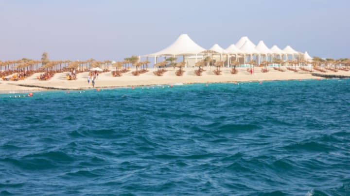 Image of Outdoors, Shelter, Summer, Nature, Sea, Water, Landscape, Scenery, Land, Waterfront, Beach, Coast, Shoreline, Hotel, Resort, Sky,