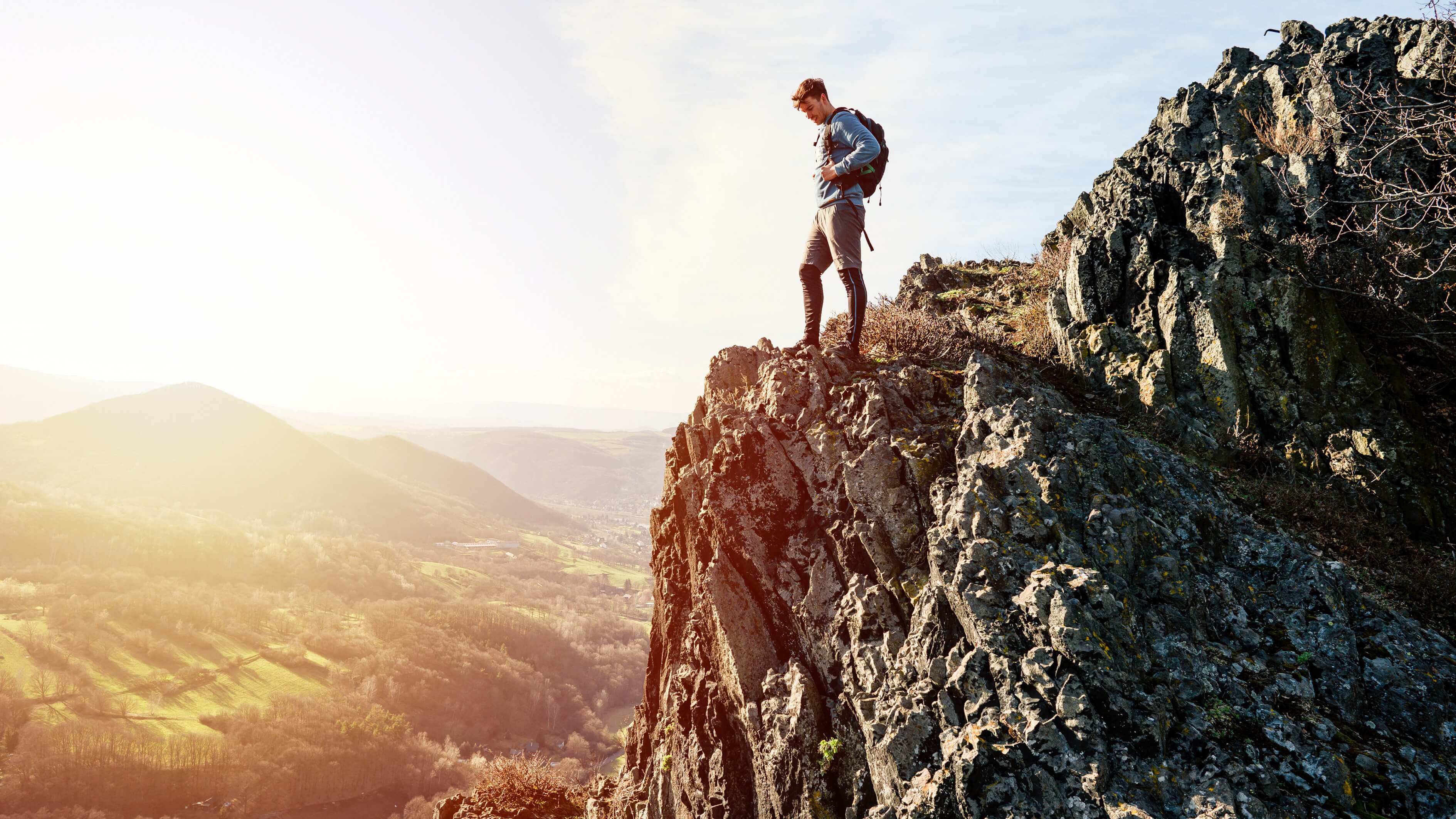 Image of Photography, Cliff, Nature, Outdoors, Adventure, Hiking, Person, Rock, Mountain, Mountain Range, Peak, Standing, Scenery, Backpack, Bag, Wilderness, 