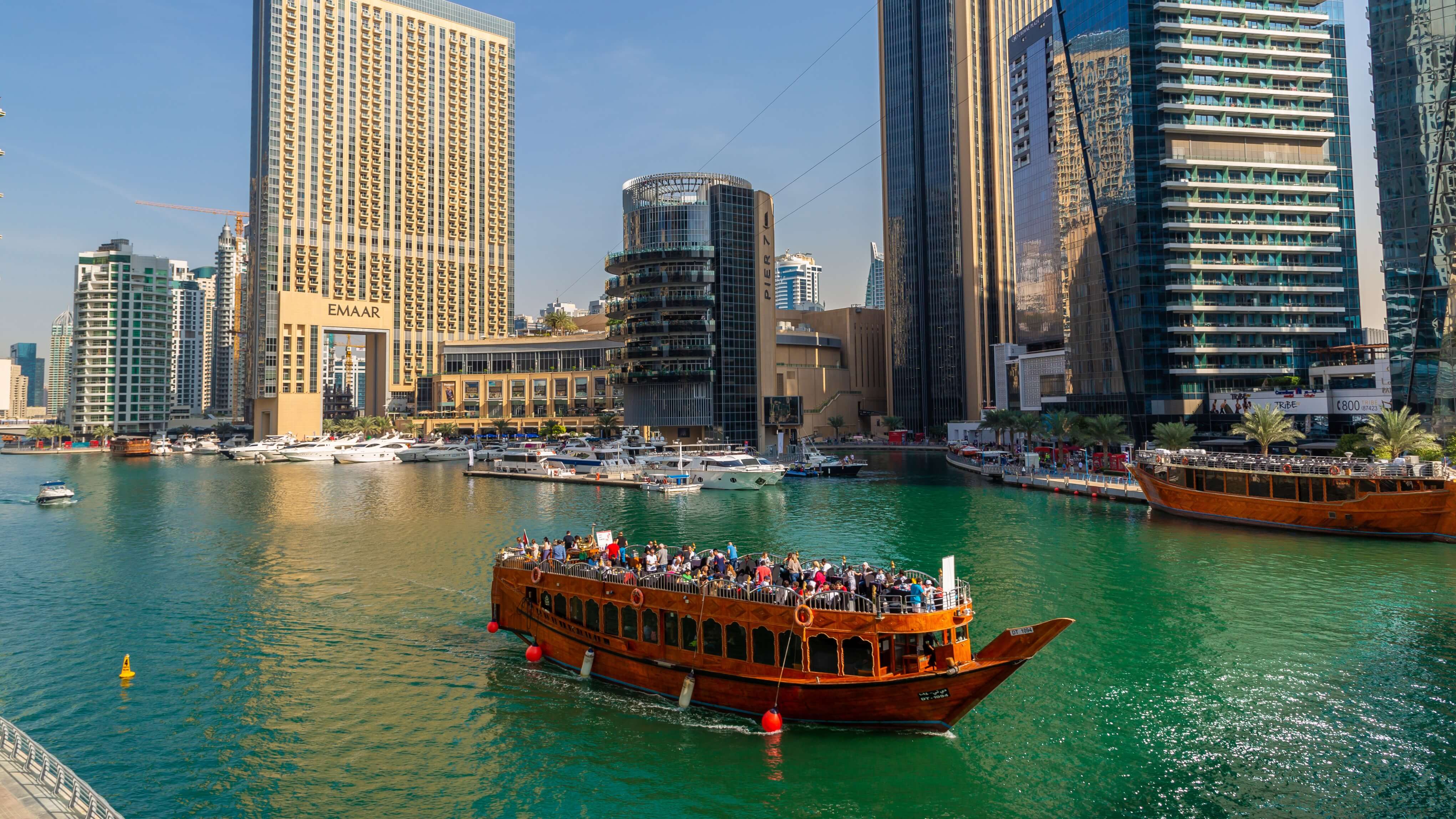 Image of City, Urban, Cityscape, Metropolis, Water, Waterfront, Boat, Vehicle, Yacht, Nature, Outdoors, Scenery, Ferry, Boating, Water Sports, Harbor, Pier, Construction Crane, 