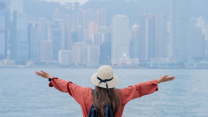 Image of City, Hat, Nature, Outdoors, Weather, Adult, Female, Person, Woman, Urban, Metropolis, Cityscape, Photography, Coat, 