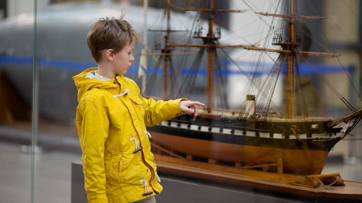 Image of Coat, Boy, Child, Male, Person, Boat, Vehicle, Raincoat, 