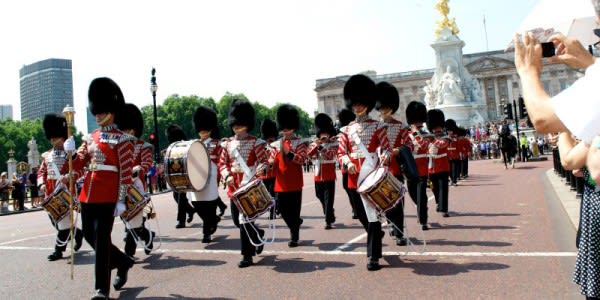 Image of People, Person, Adult, Female, Woman, Marching, Glove, Group Performance, Music, Music Band, Musical Instrument, Musician, Performer, Handbag, Shoe, Male, Man, Mobile Phone, Traffic Light, 