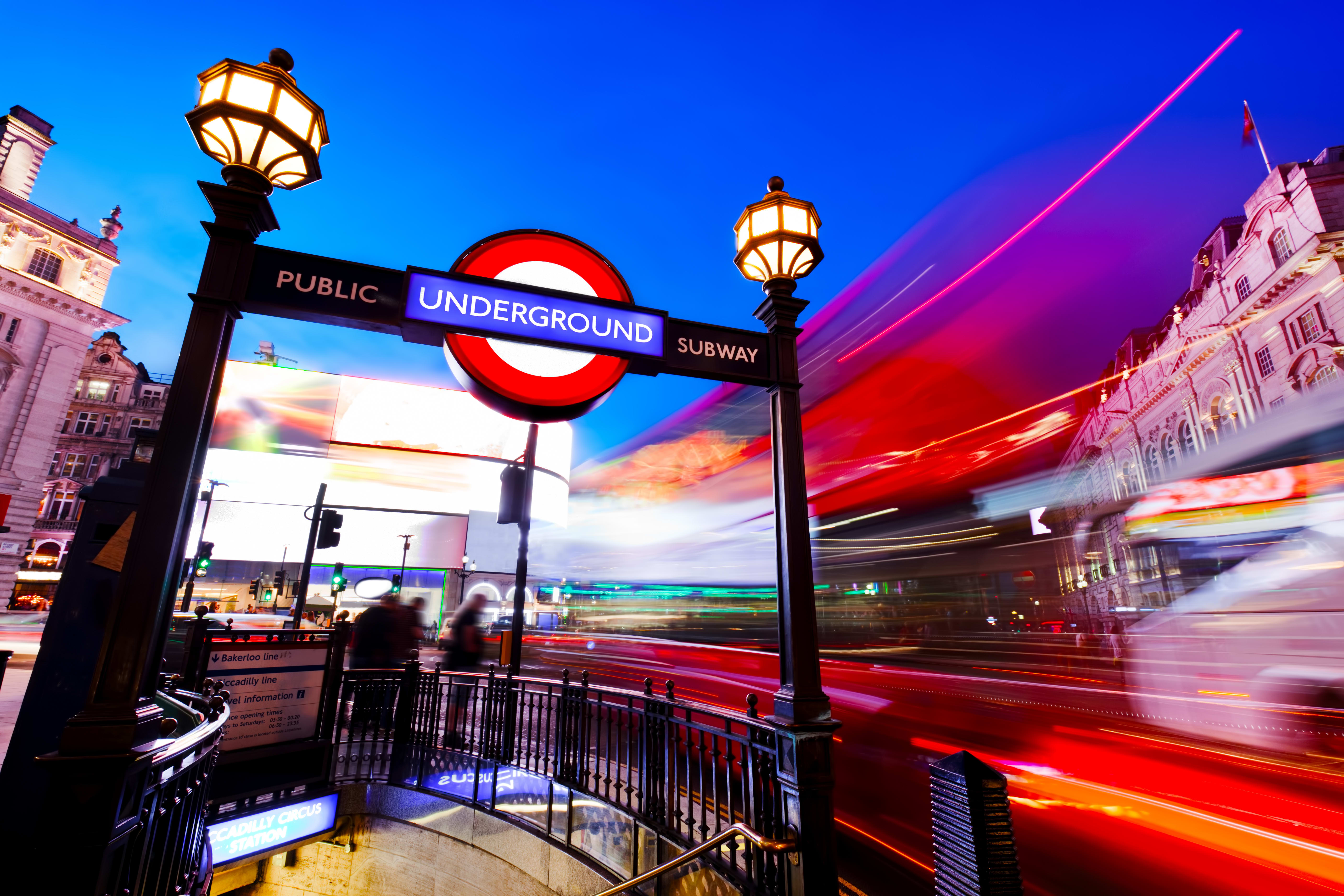 Image of City, Metropolis, Urban, Lighting, Terminal, Railway, Train, Train Station, Vehicle, Path, Sidewalk, Person, Handrail, Railing, Road, Street, Light, Traffic Light, 