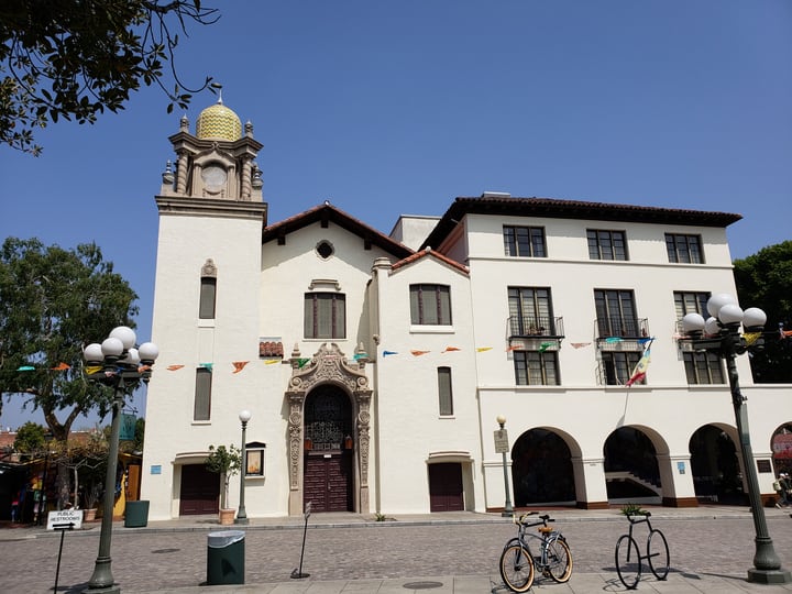 Image of Clock Tower, Tower, Plant, Bicycle, Vehicle, Arch, Person, City, Monastery, 