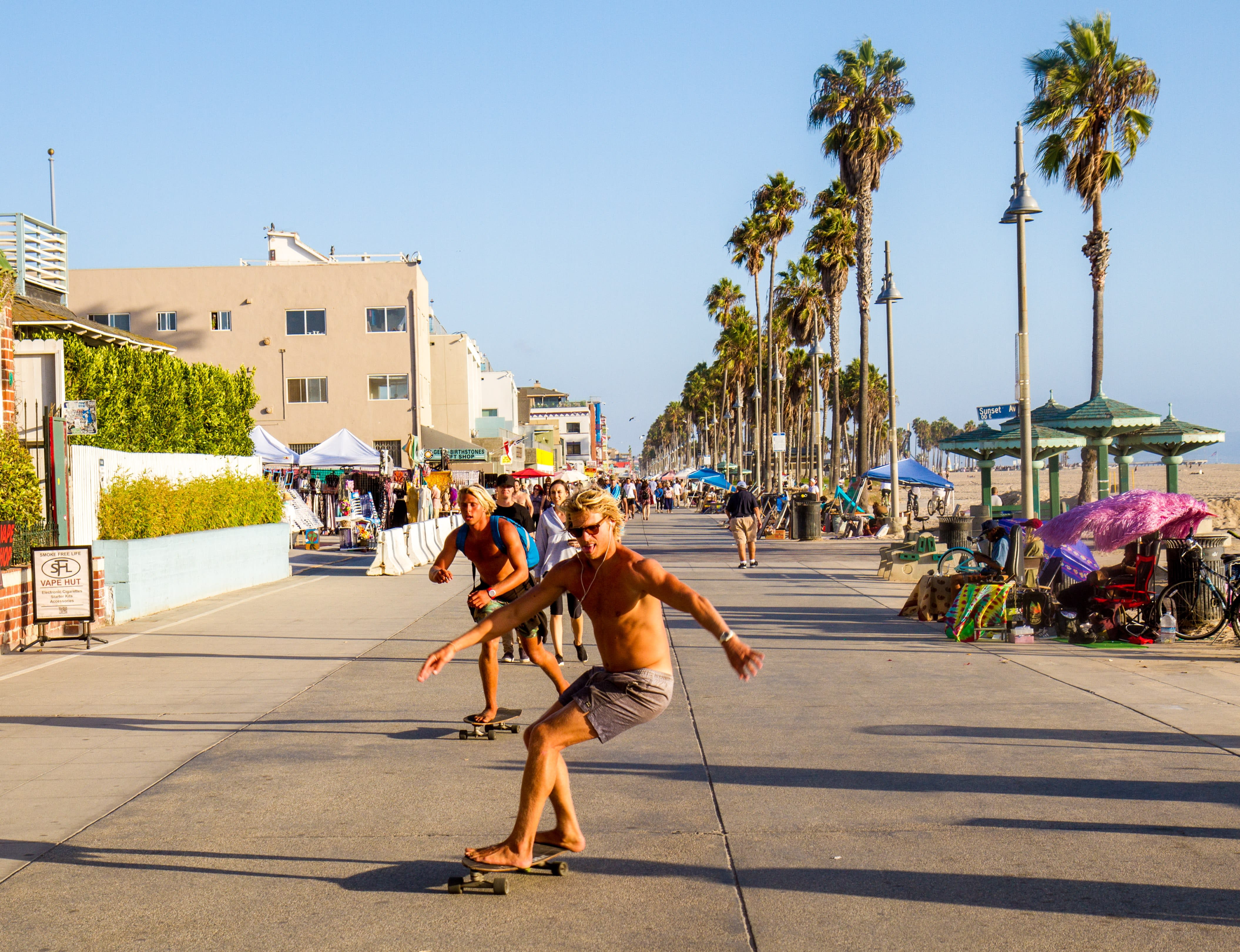 Image of Neighborhood, Palm Tree, Plant, Tree, City, Road, Street, Urban, Path, Summer, Boy, Male, Person, Teen, Sidewalk, People, Skateboard, Building, 