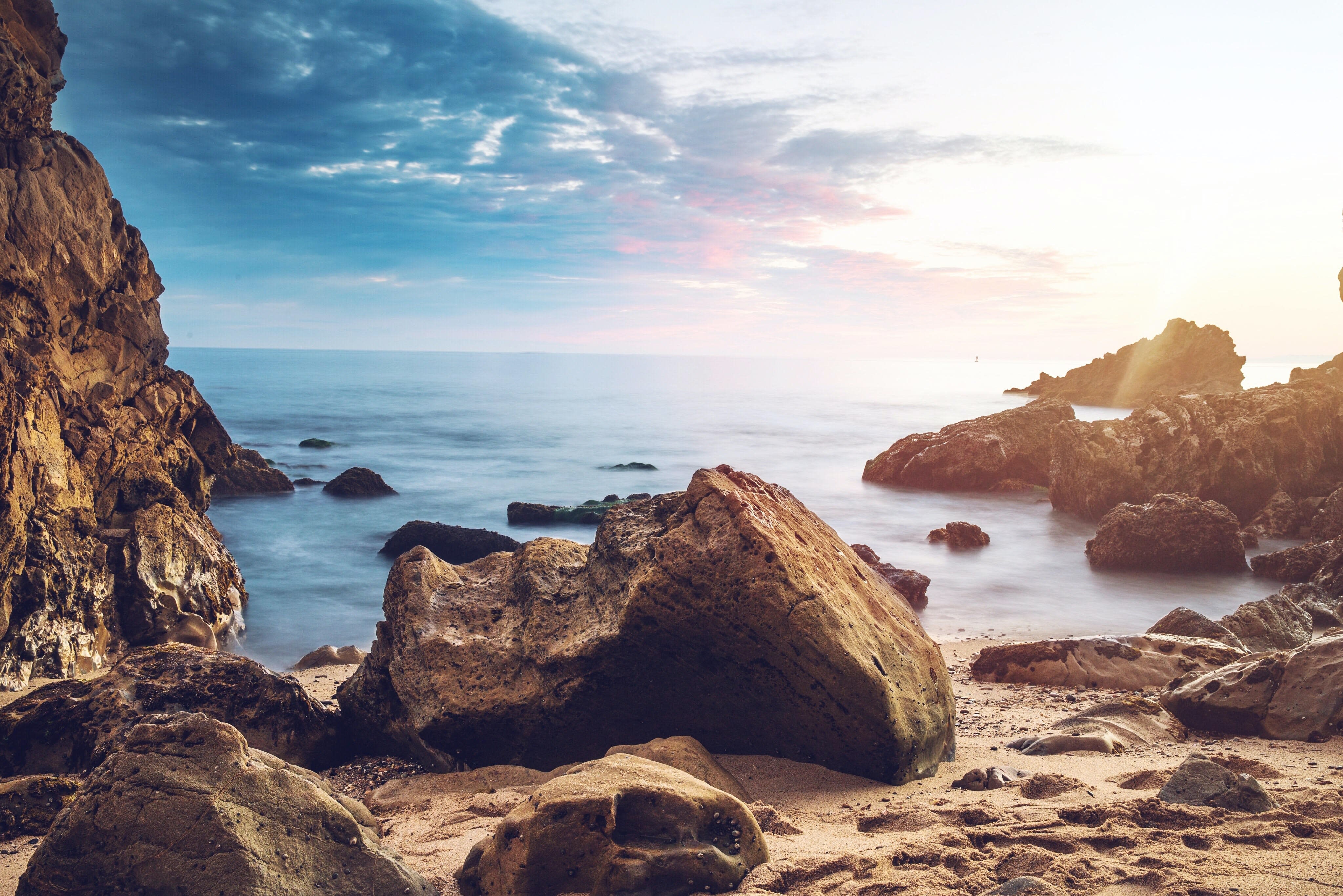 Image of Rock, Landscape, Nature, Outdoors, Scenery, Beach, Coast, Sea, Shoreline, Water, Sky, Promontory, Cliff, Cave, Cove, Wilderness, Horizon, 