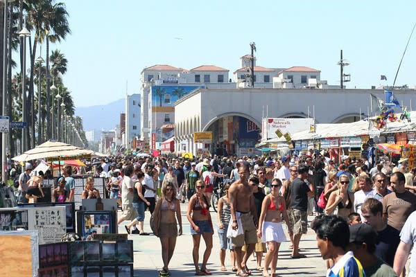 Image of Fun, Person, Tourist, Vacation, Handbag, Boardwalk, Bridge, Spring Break, Hat, Boy, Male, Teen, People, Shoe, Adult, Man, City, Urban, Shorts,