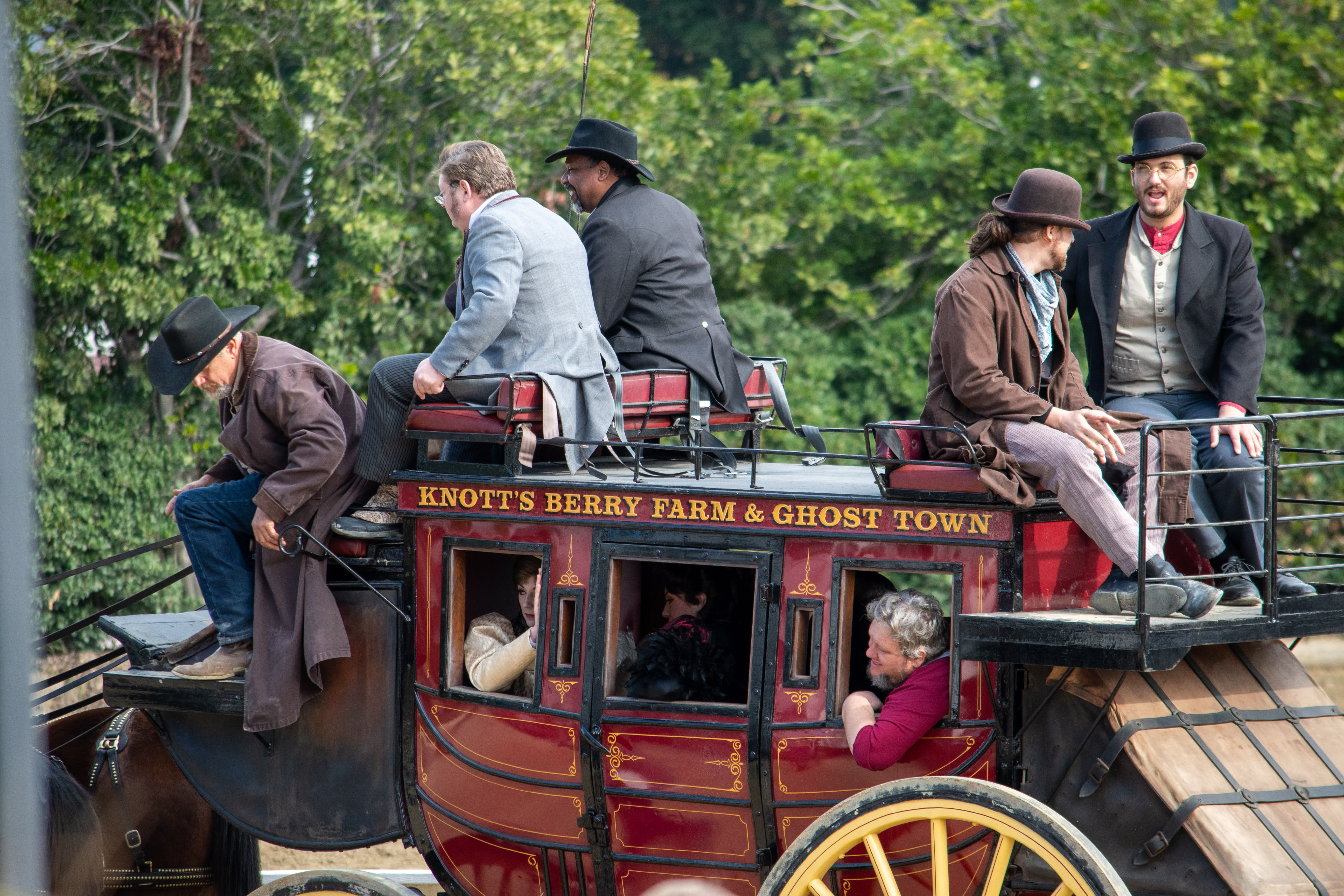 Image of Hat, Adult, Male, Man, Person, Coat, Machine, Spoke, Carriage, Vehicle, 