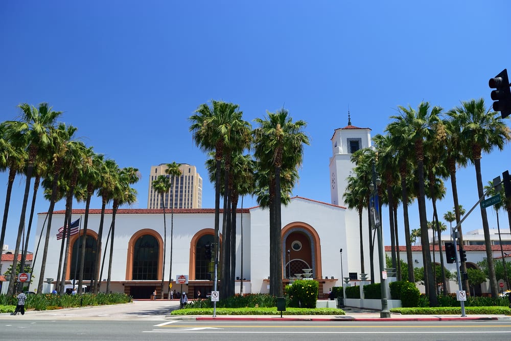 Image of Summer, Tree, Palm Tree, Traffic Light, City, Person, Building, Clock Tower, Tower, Office Building, Arch, Car, 