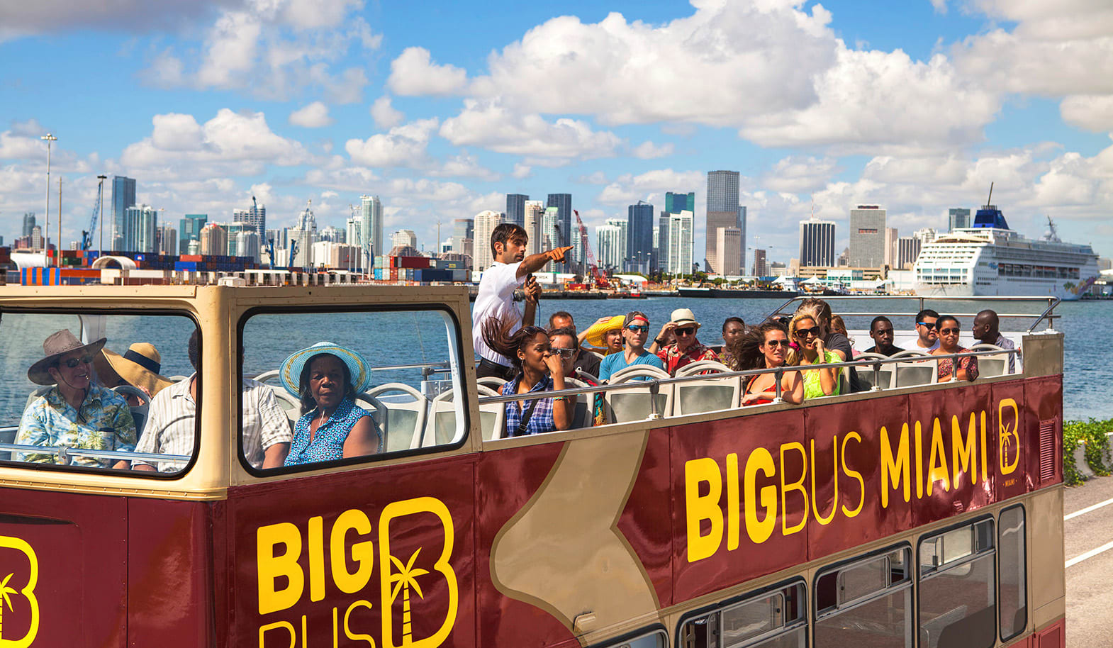Image of City, Person, Adult, Female, Woman, Male, Man, Metropolis, Urban, Water, Waterfront, Boat, Vehicle, Cityscape, Bus, Chair,