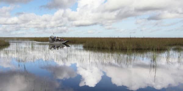 Image of Land, Nature, Outdoors, Scenery, Pond, Water, Sky, Landscape, Boat, Canoe, Canoeing, Rowboat, Vehicle, Water Sports, Swamp, 