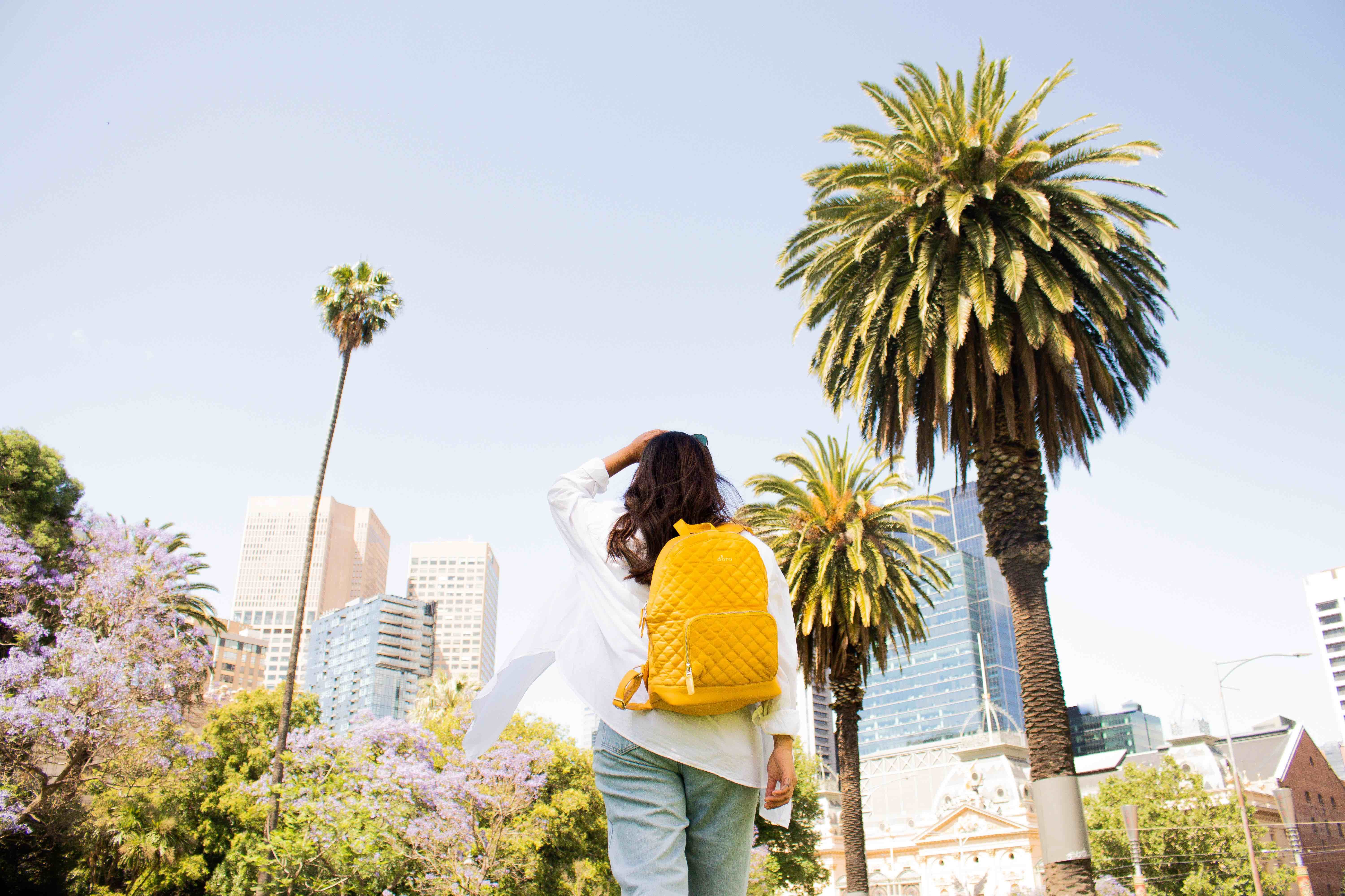 Image of Photography, Tree, Adult, Female, Person, Woman, Pants, Walking, Backpack, Bag, 