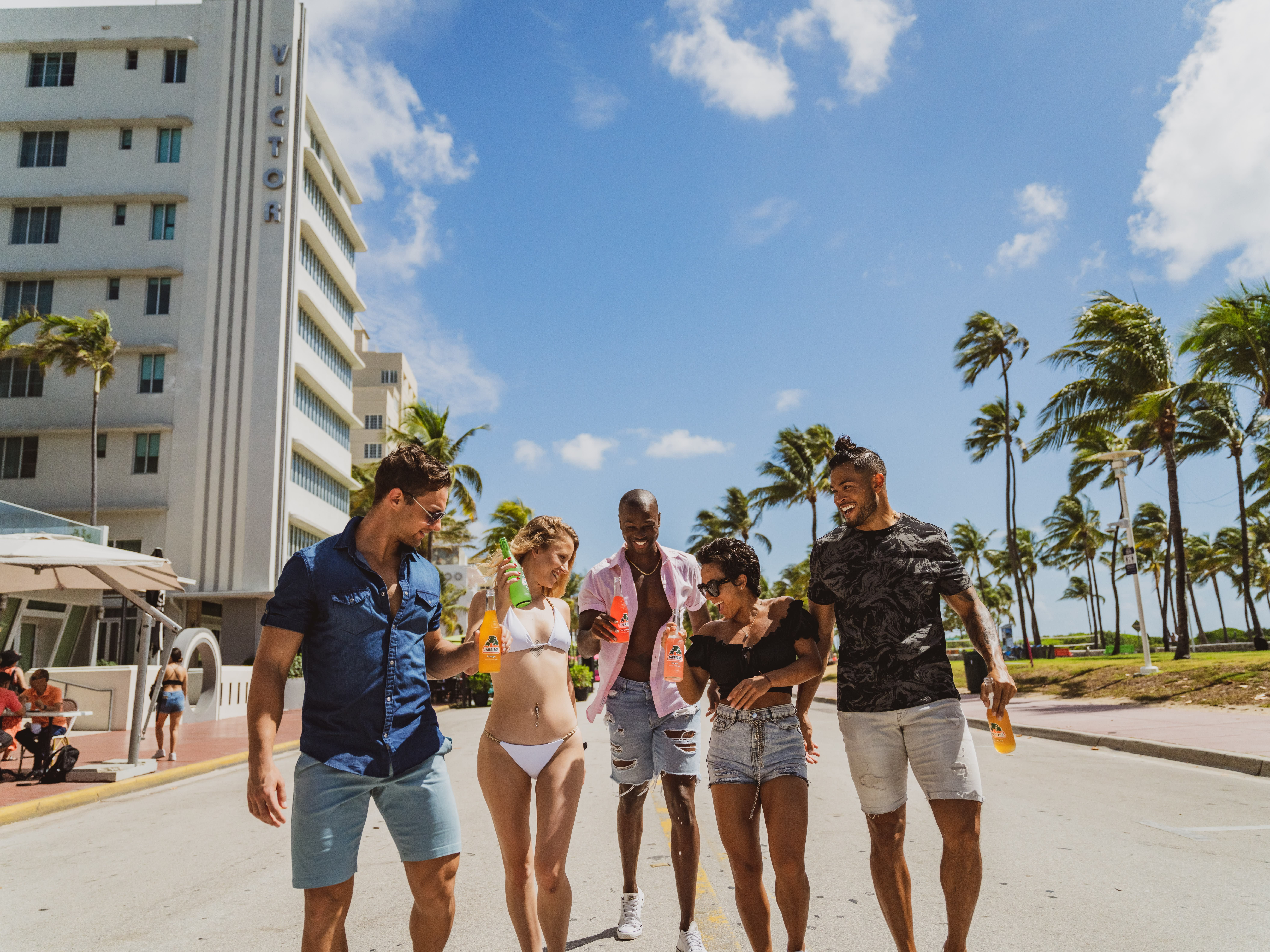 Image of Shorts, Summer, Person, Walking, City, Tree, People, Urban, Palm Tree, Adult, Male, Man, Boy, Teen, Fun, Vacation, Shoe, Neighborhood, Glasses,
