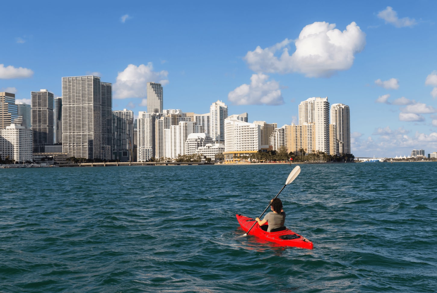 Image of City, Metropolis, Urban, Boat, Canoe, Kayak, Rowboat, Vehicle, Water, Cityscape, Kayaking, Person, Water Sports, 