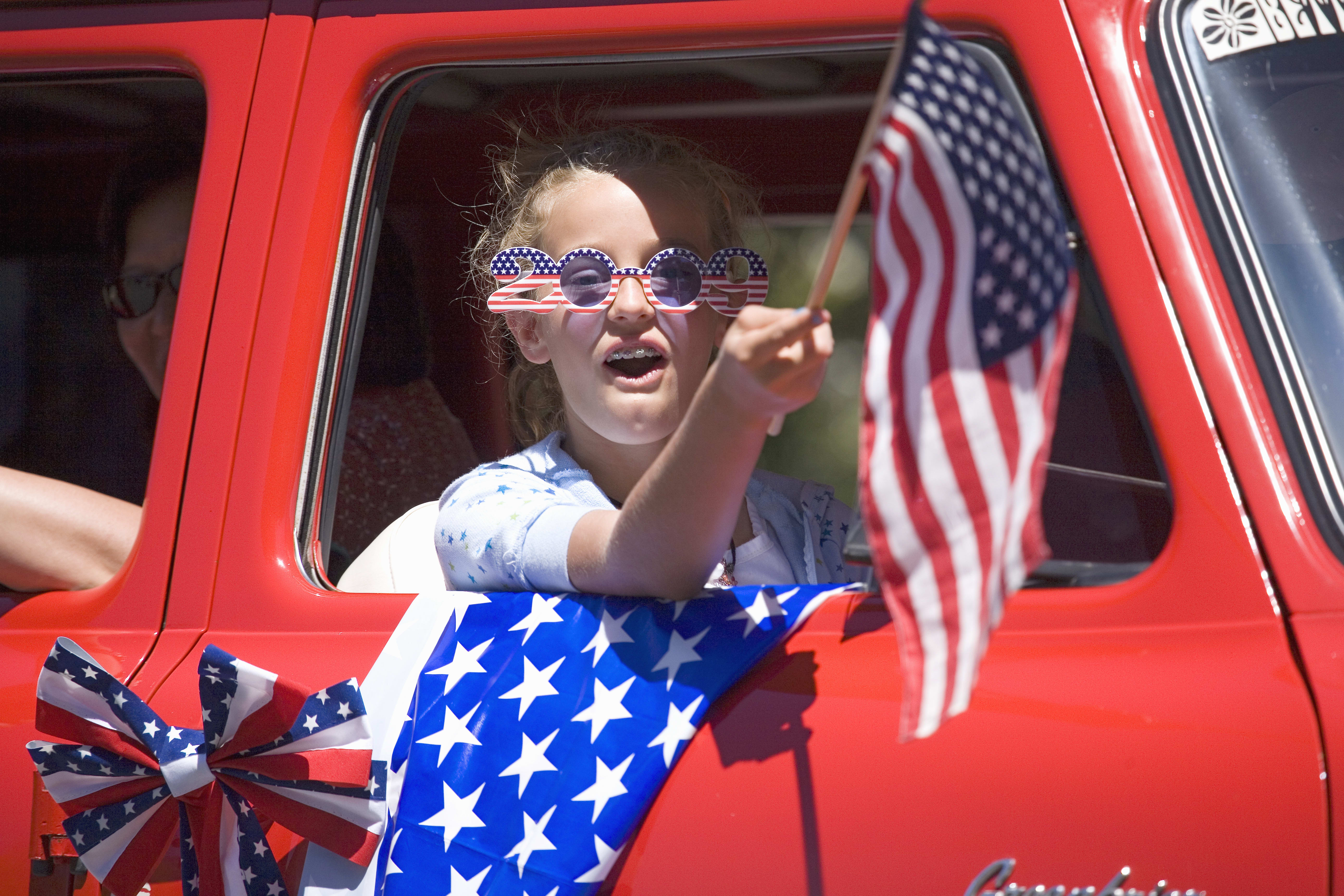 Image of Baby, Person, Car, Vehicle, Adult, Female, Woman, American Flag, Flag, Accessories, Glasses, 