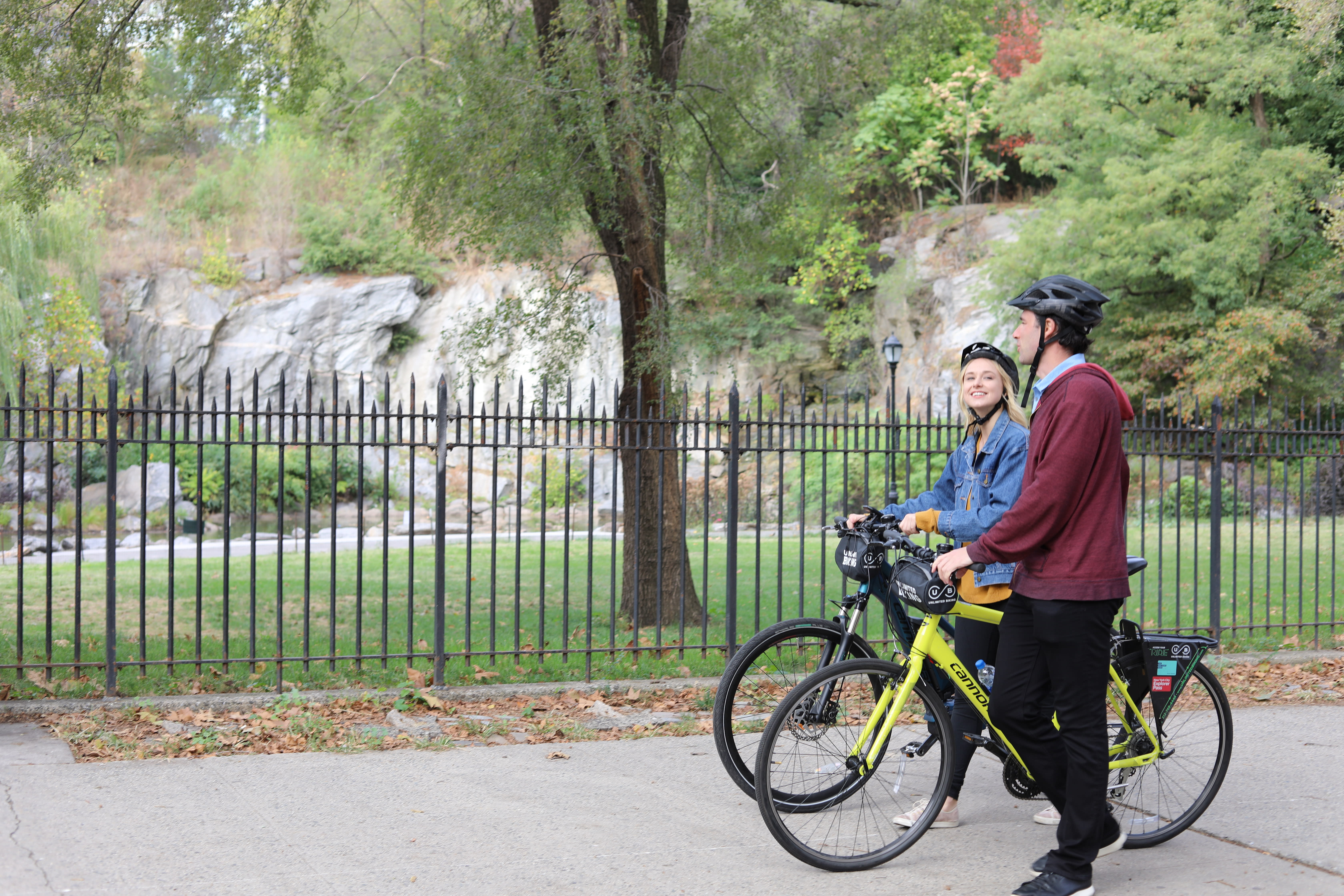 Image of Vegetation, Tree, Bicycle, Vehicle, Adult, Male, Man, Person, Grass, Nature, Outdoors, Park, Female, Woman, Helmet, Land, Woodland, 