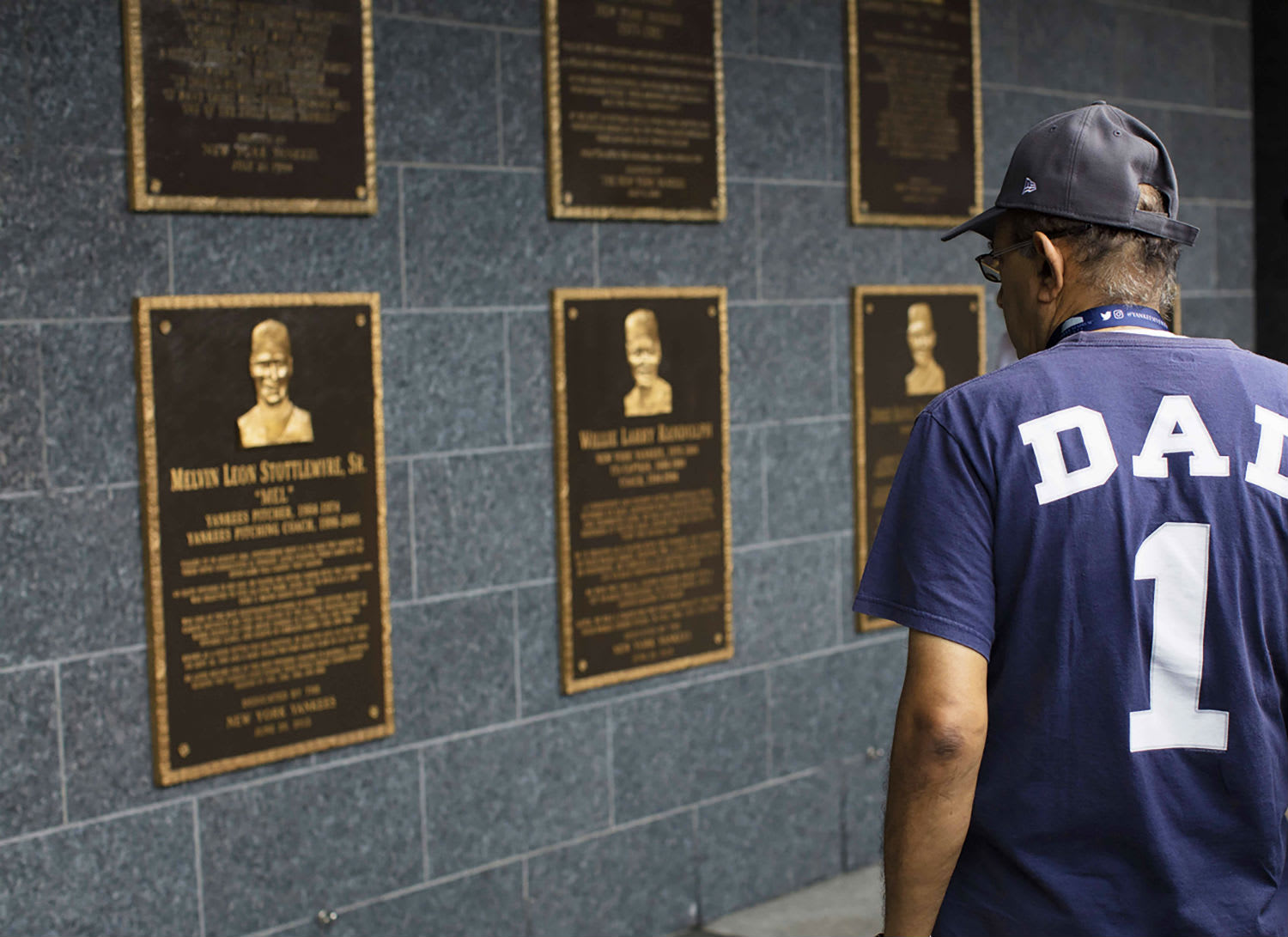 Image of People, Person, T-Shirt, Baseball Cap, Cap, Hat, Adult, Male, Man, Plaque, 