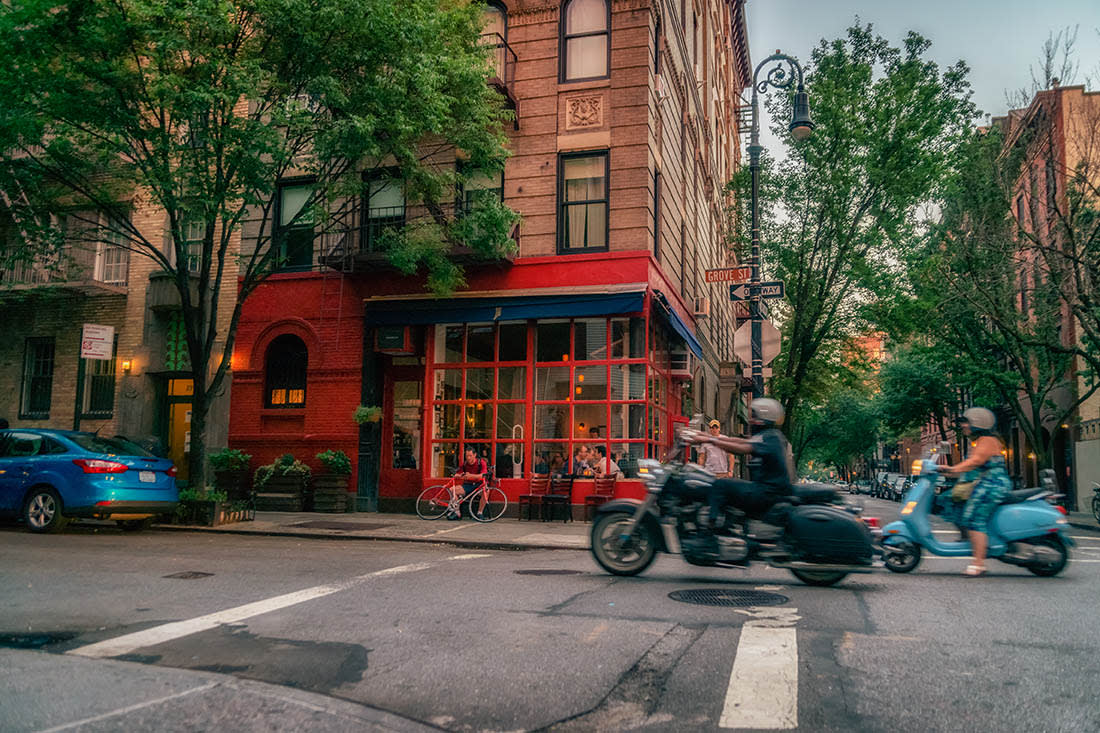 Image of Neighborhood, City, Road, Street, Urban, Person, Car, Vehicle, Motorcycle, Moped, Motor Scooter, Adult, Male, Man, Chair, Bicycle, Machine, Wheel, 