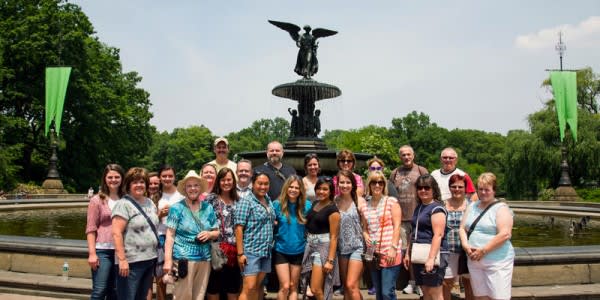 Image of Grass, Nature, Outdoors, Park, People, Person, Fountain, Water, Face, Head, Photography, Portrait, Shorts, Accessories, Handbag, Hat, Fun, Tourist, Vacation, Vegetation, Shoe, Tree, 