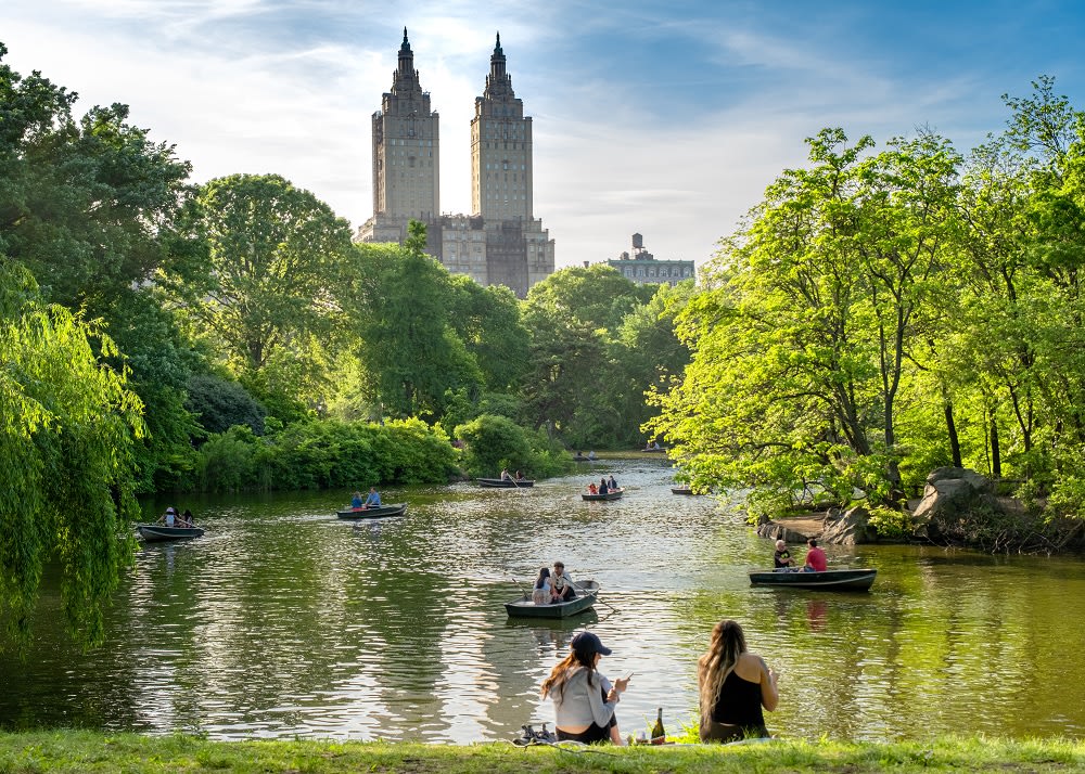 Image of Nature, Outdoors, Scenery, Grass, Park, Pond, Water, Vegetation, Boat, Vehicle, Bell Tower, Tower, Person, Tree, Hat, Land, Woodland, Canoeing, Rowboat, Water Sports, 