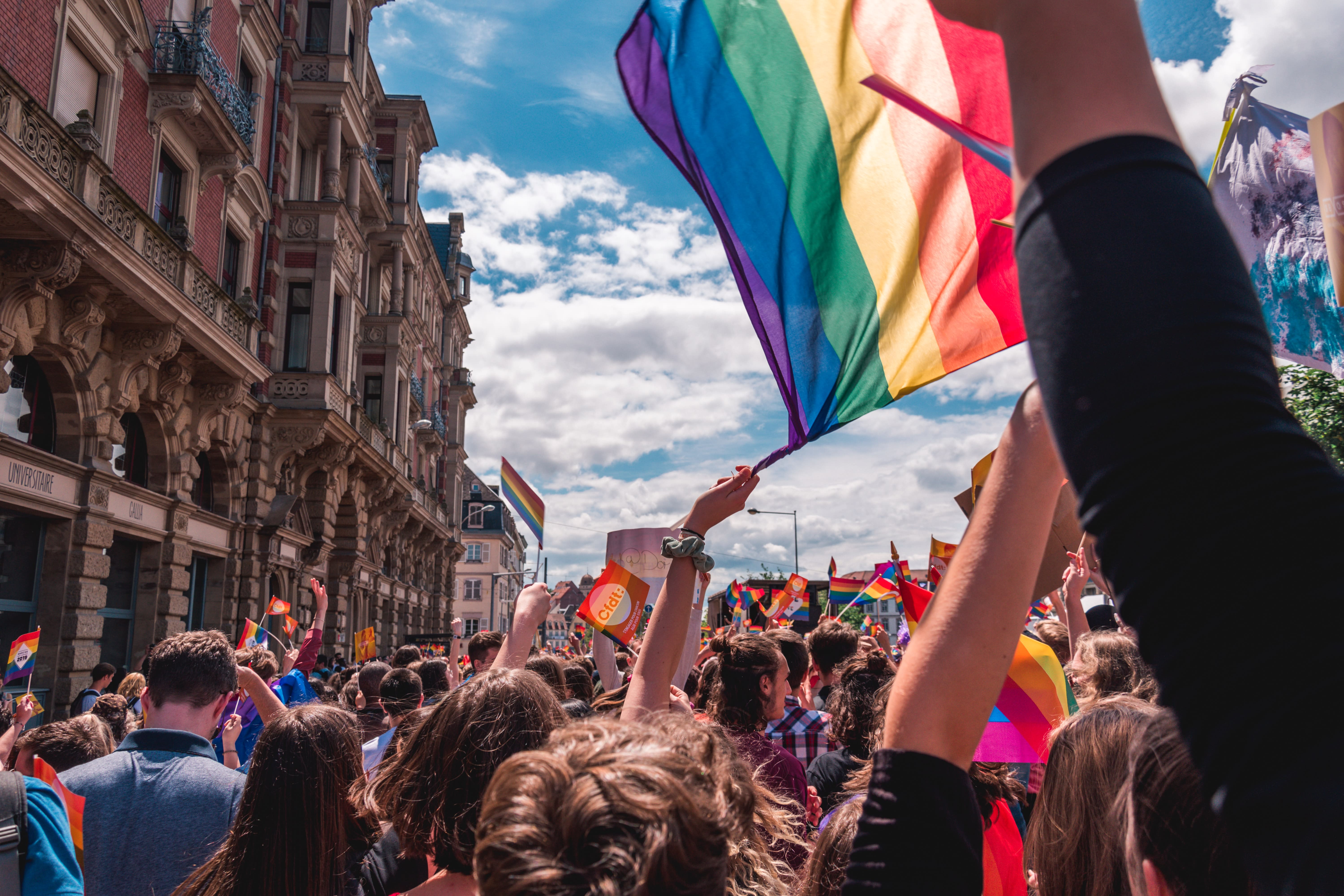 Image of Parade, Person, Pride Parade, Adult, Female, Woman, Flag, Male, Man, Wristwatch, 