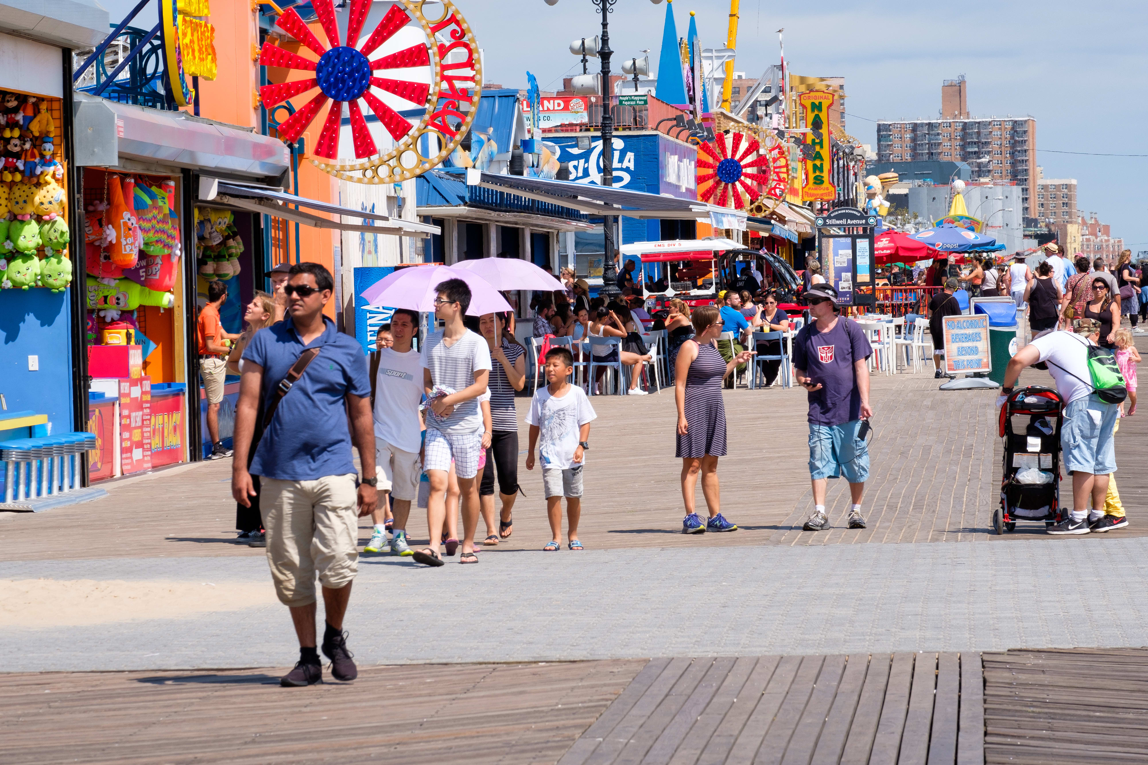 Image of Boardwalk, Bridge, Shorts, Path, Person, Adult, Male, Man, Sidewalk, Female, Woman, Bag, Handbag, City, Amusement Park, Fun, Theme Park, Walking, 