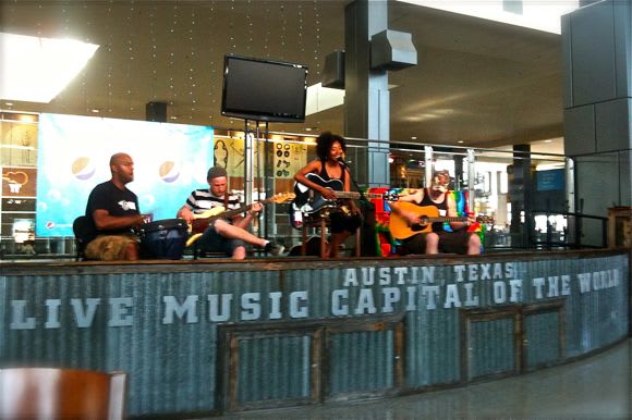 Image of Adult, Female, Person, Woman, Male, Man, Electronics, Screen, Computer Hardware, Hardware, Monitor, Guitar, Musical Instrument, Hat,