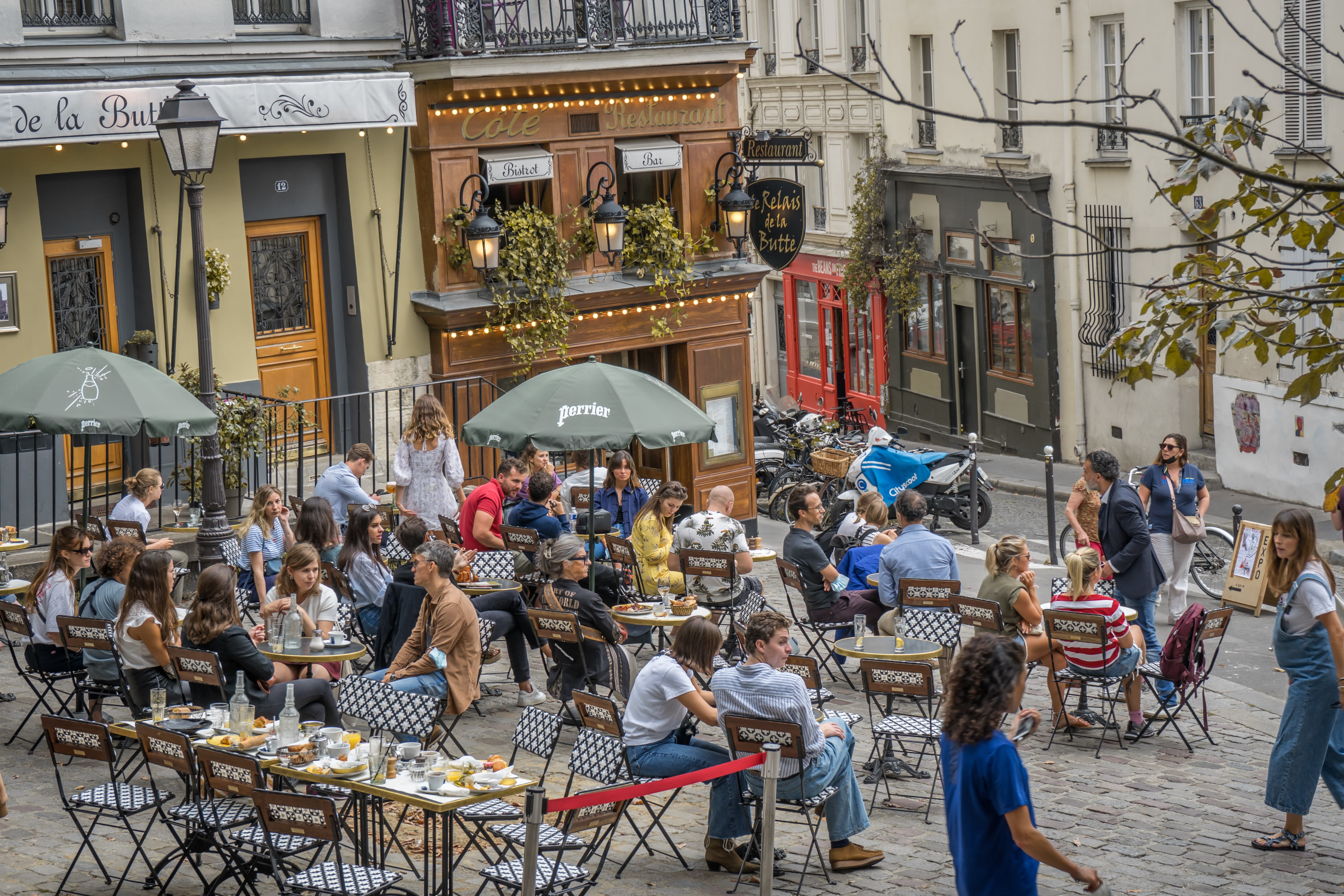 Image of Urban, Indoors, Restaurant, People, Person, City, Handbag, Sandal, Adult, Female, Woman, Child, Girl, Cafeteria, Chair, Furniture, Male, Man, Cafe, Shoe, Cup, Brunch, Food, Motorcycle, Bicycle, 