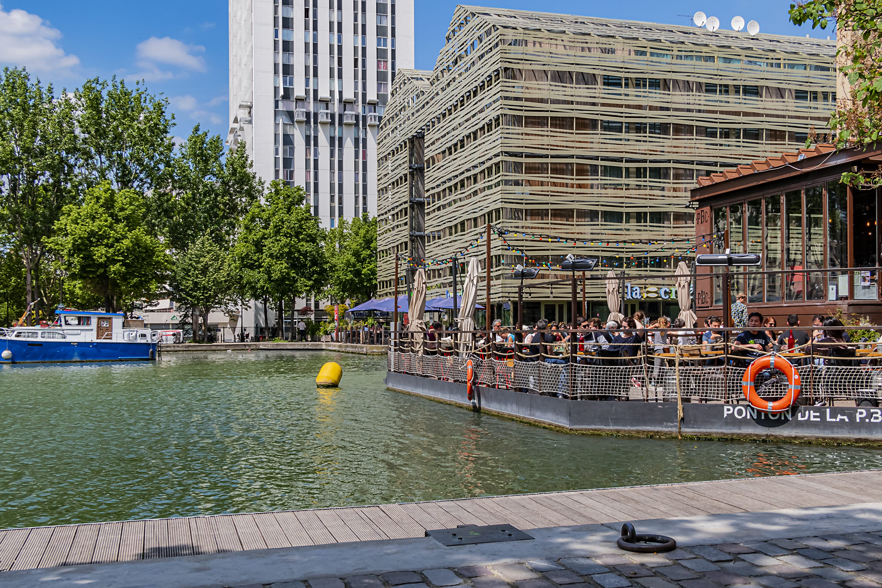 Image of Water, Waterfront, City, Metropolis, Urban, Boat, Vehicle, Watercraft, Canal, Outdoors, Nature, Scenery, Person, Office Building, Port, Pier, 