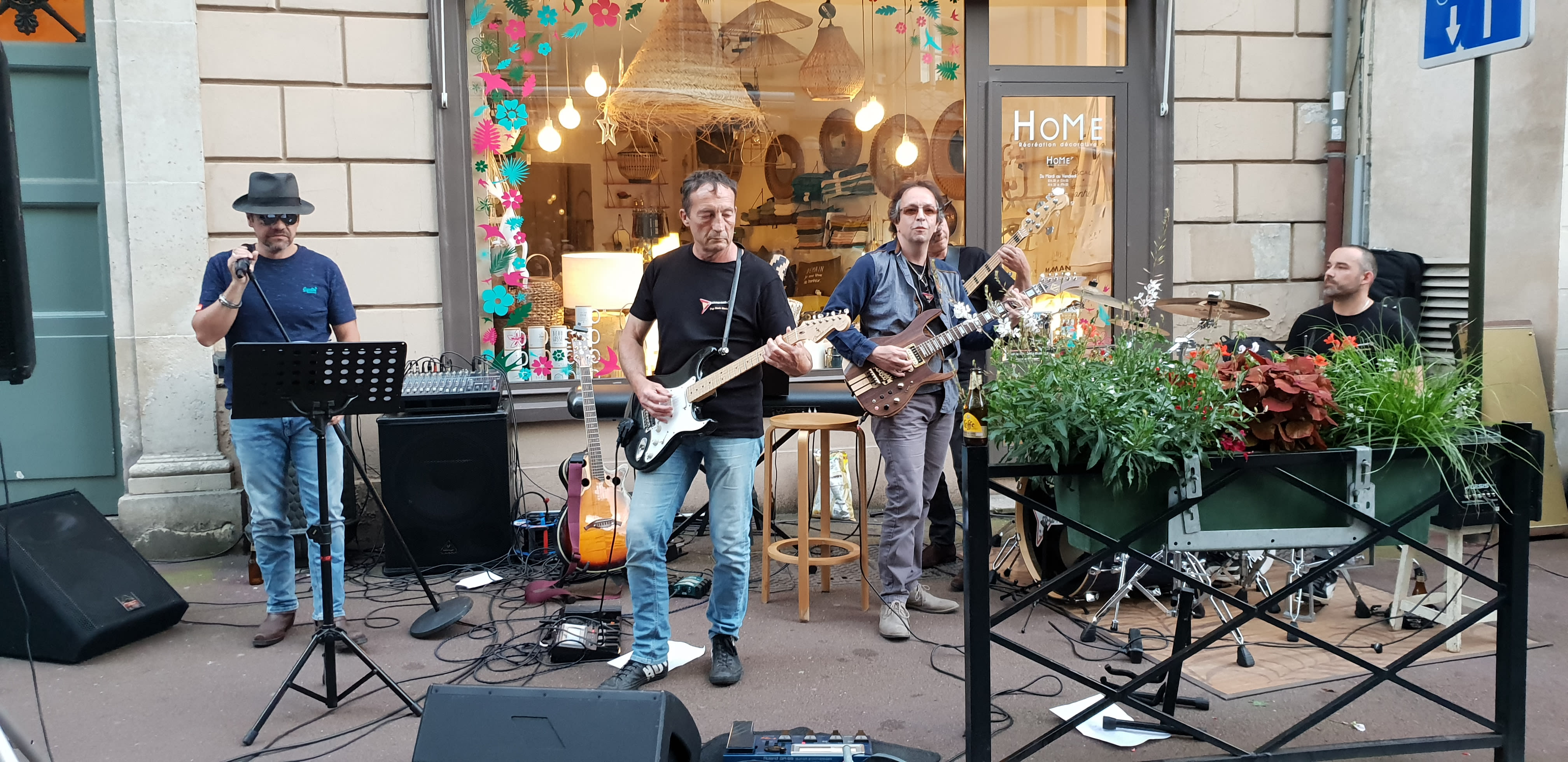 Image of Plant, Potted Plant, Group Performance, Music, Music Band, Musical Instrument, Musician, Performer, Person, Adult, Male, Man, Guitar, Jar, Planter, Pottery, Vase, Guitarist,