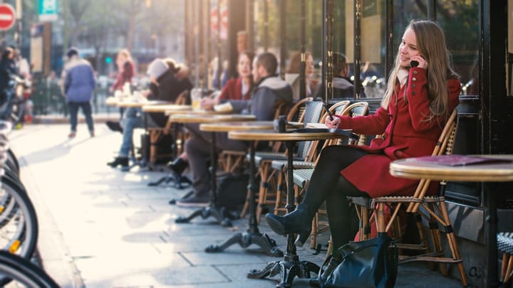 Image of Face, Head, Person, Adult, Female, Woman, Smoke, Chair, Furniture, Male, Man, Indoors, Restaurant, Handbag, 