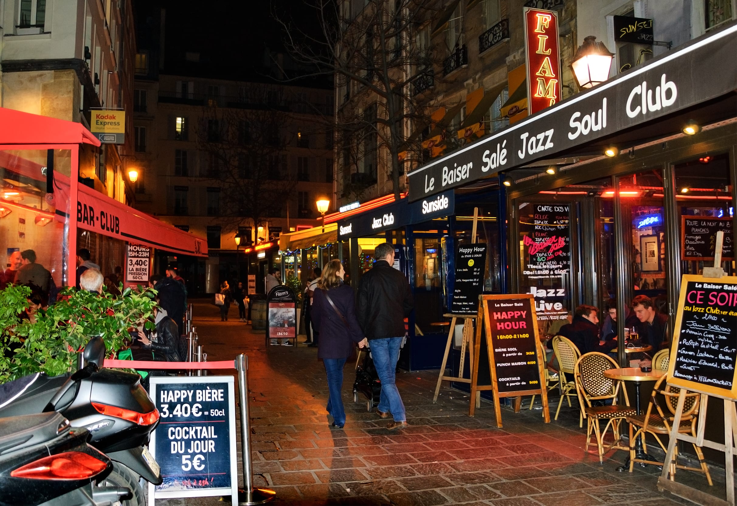 Image of Indoors, Restaurant, Urban, Cafeteria, Cafe, Path, Person, City, Chair, Furniture, Walkway, Motorcycle, Vehicle, Sidewalk, Handbag, Road, Street, Dining Table, Table, Jeans, Pants,