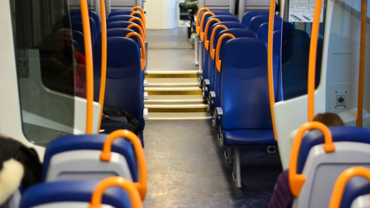 Image of People, Person, Chair, Furniture, Adult, Female, Woman, Boy, Child, Male, Terminal, Bus, Vehicle, 